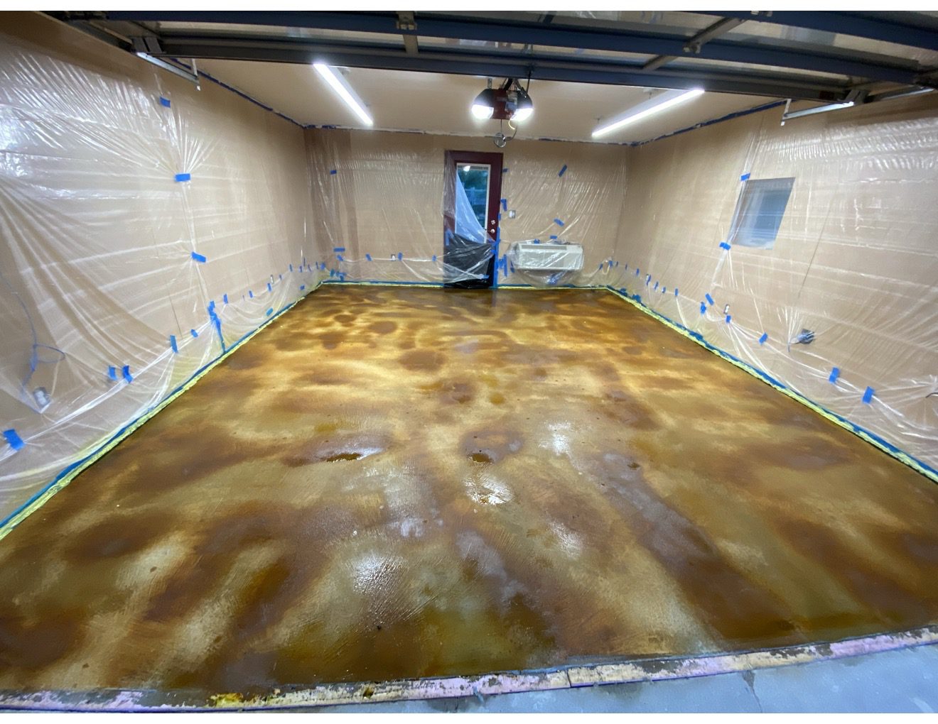 Applying the acid-stain to the garage floor
