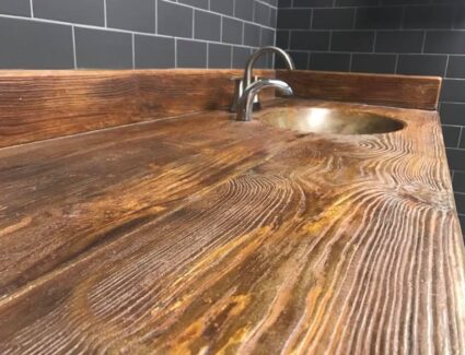 Concrete vanity stained to look like wood