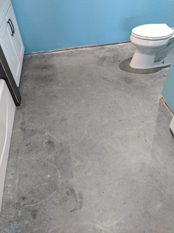 Unfinished concrete bathroom floor