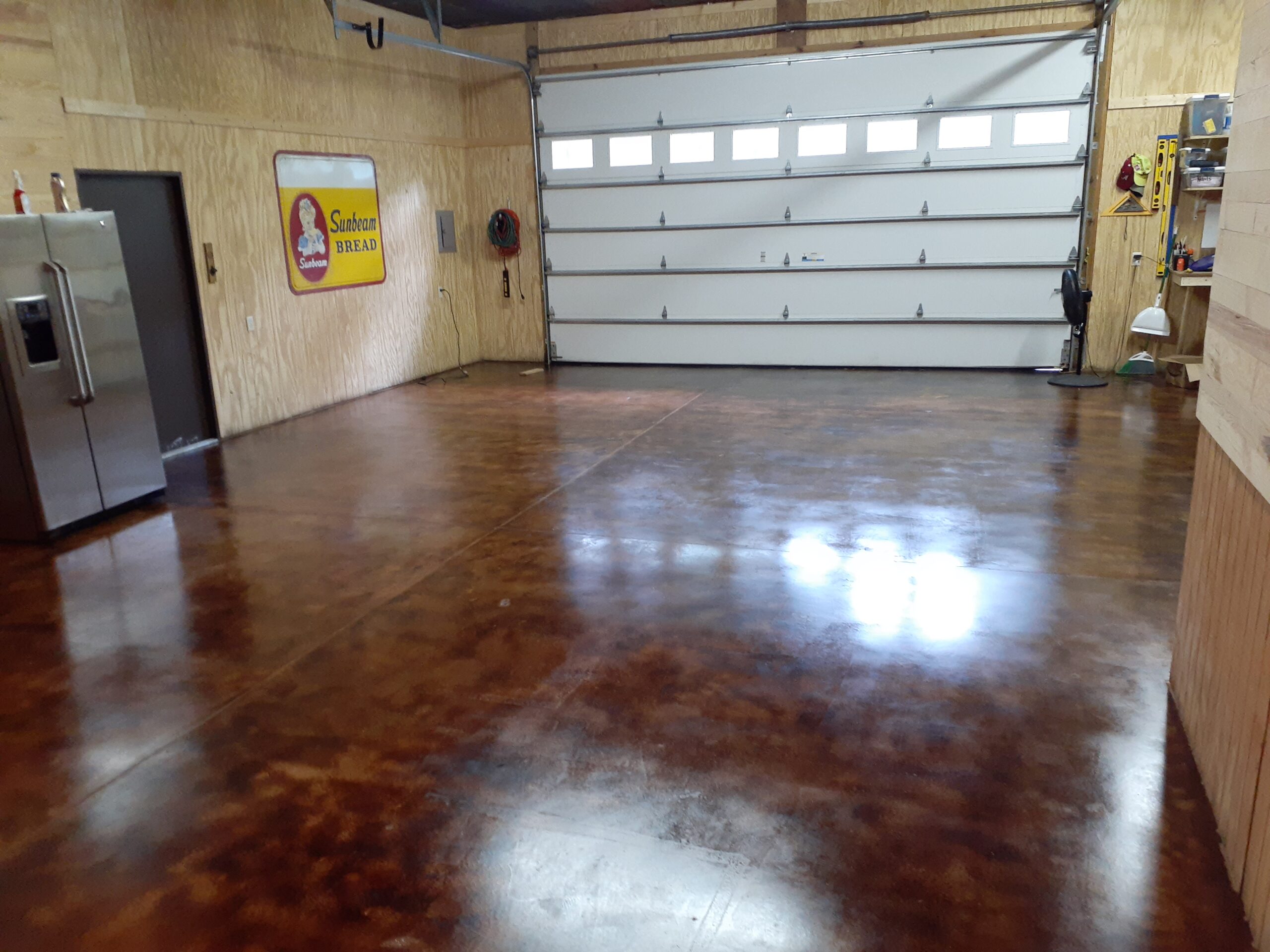 Stunning final result of coffee brown acid stain concrete garage floor after applying high gloss EasySeal sealer.