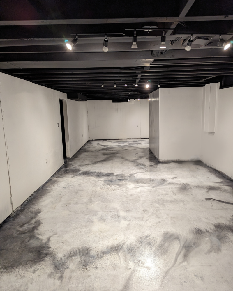 Photograph of the finished basement floor, gleaming with sealer and gloss wax