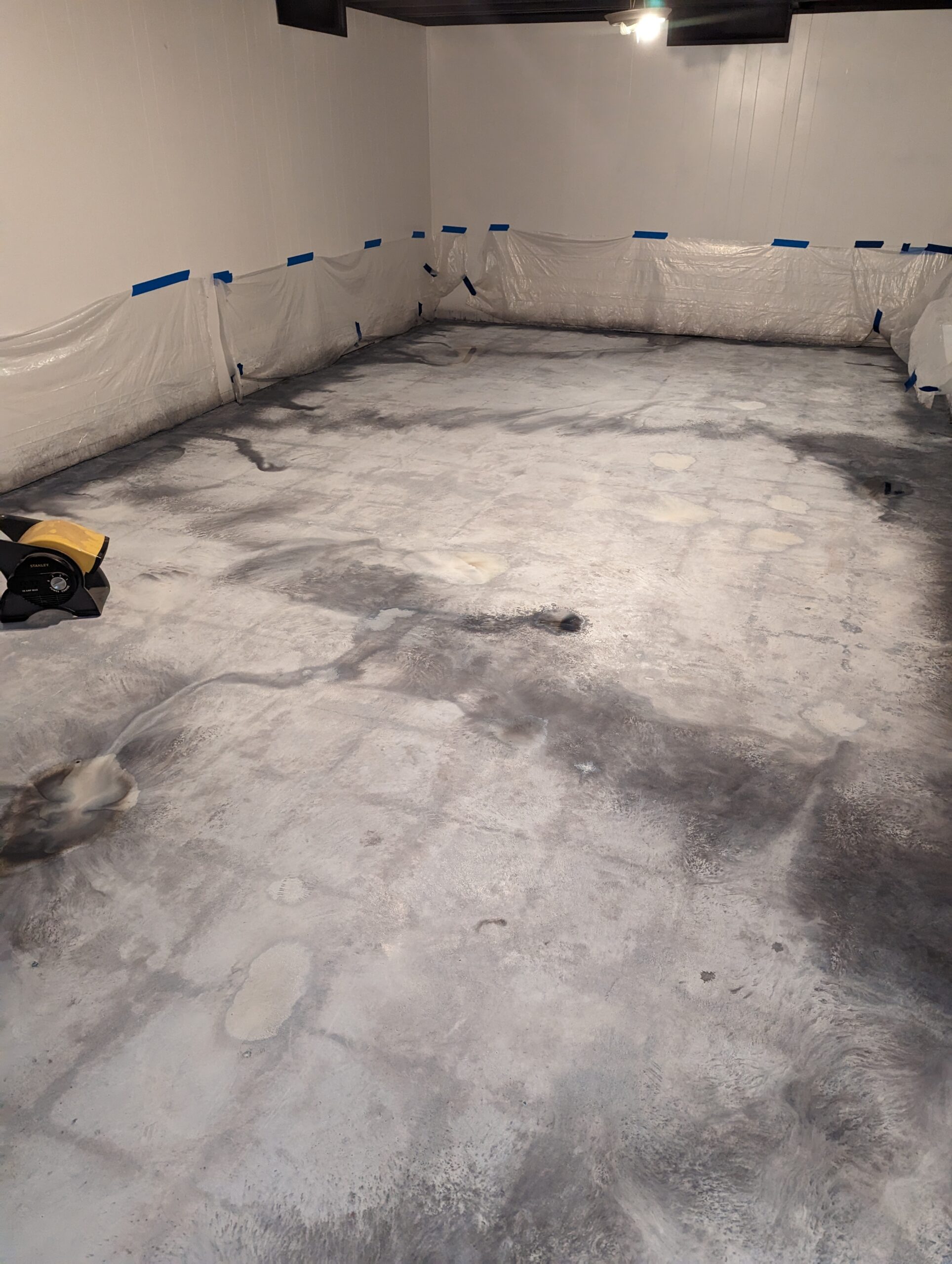 Photo of the dry stained floor, showing tile ghosting prior to sealer application