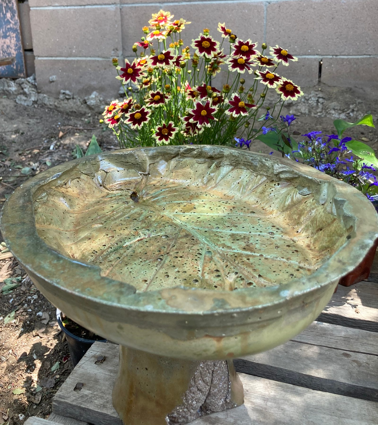 A tastefully stained bird bath showing the successful blending of two EverStain colors. The uneven surface and numerous crevices and divots of the bird bath are evident, demonstrating the intricate nature of the project