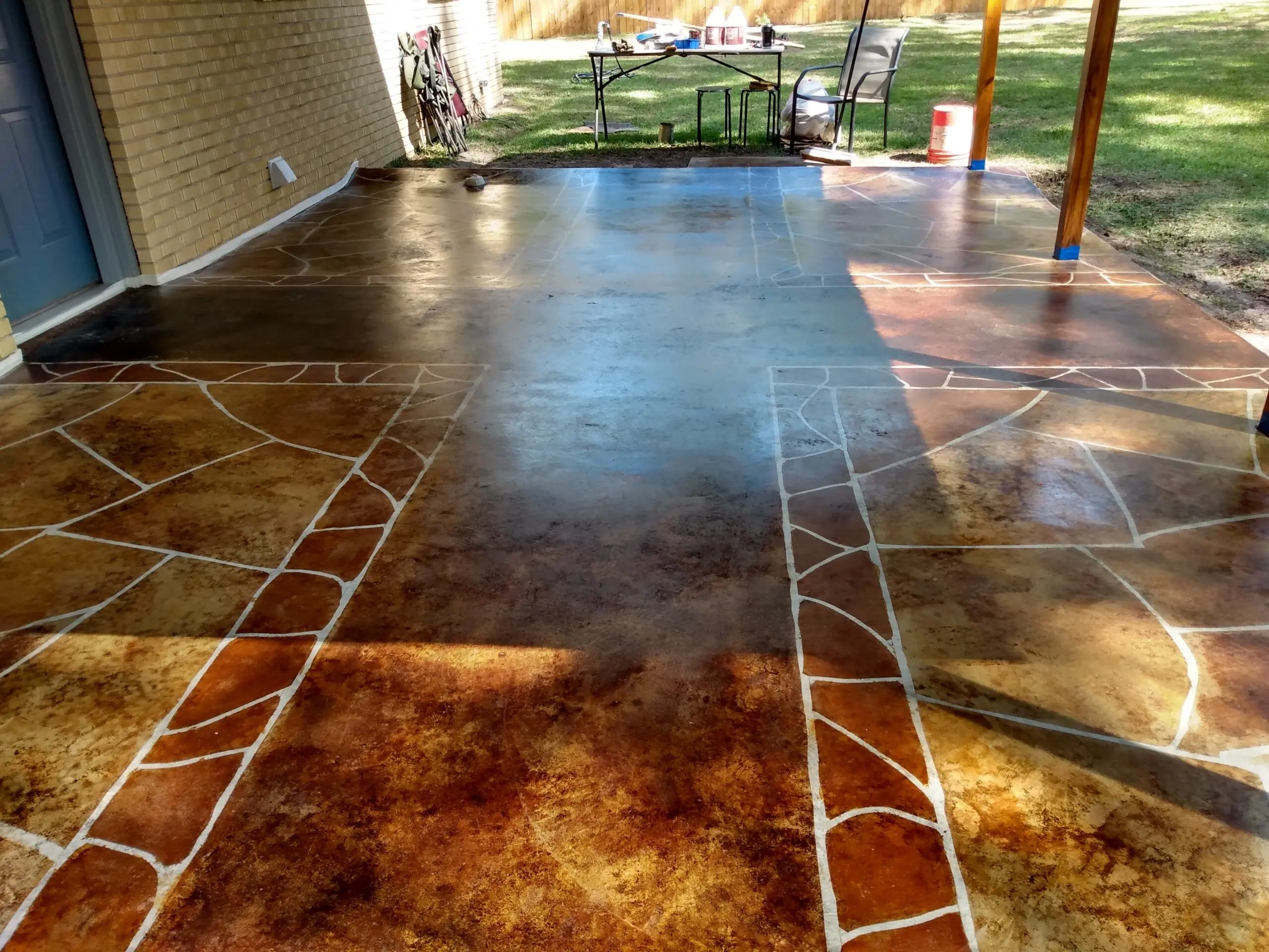 "Close-up image of the completed faux flagstone porch, showcasing the detailed color variations and patterns achieved with acid staining