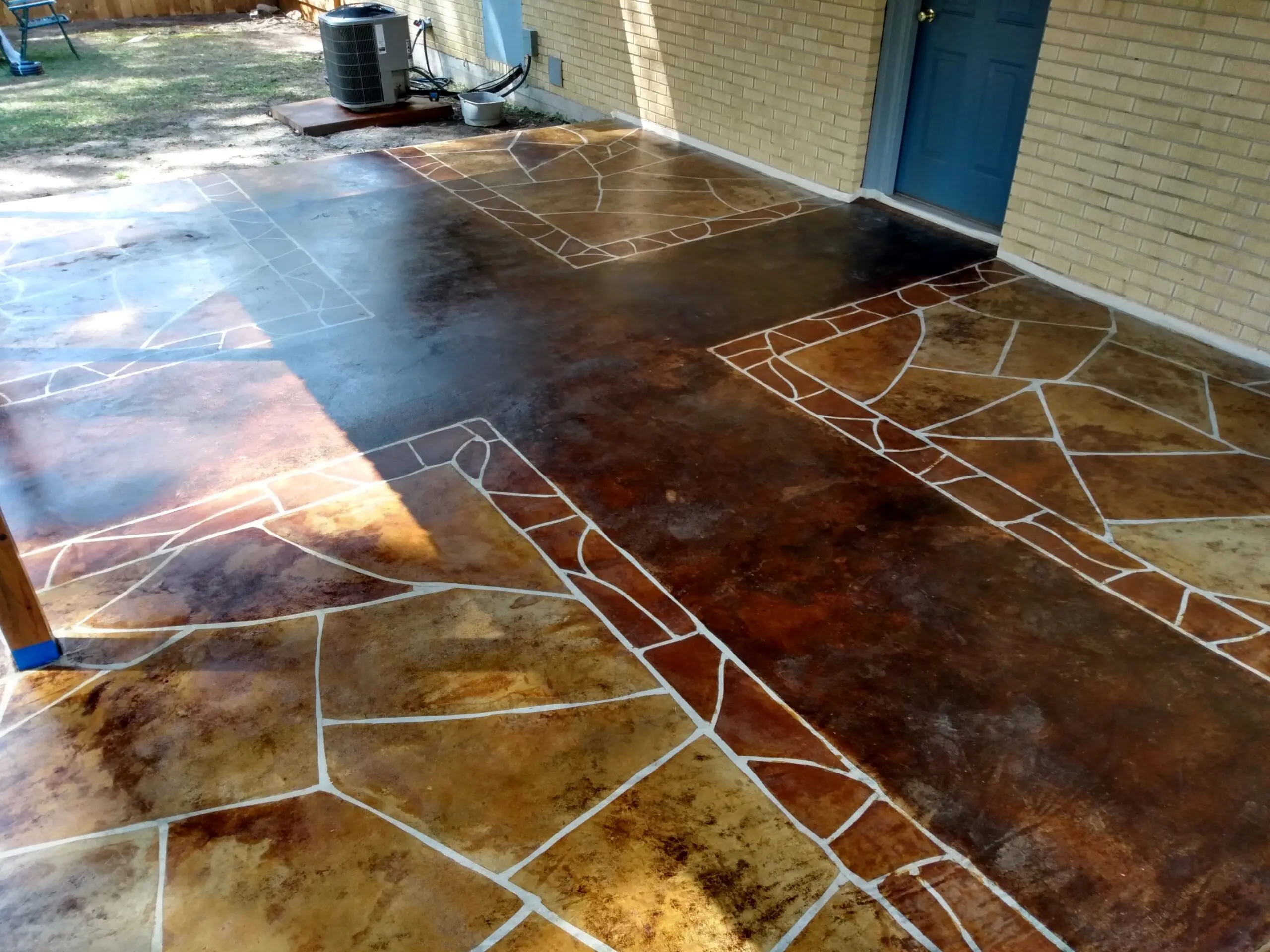 Image displaying the completed faux flagstone porch, with vibrant colors and unique design, fully transformed after the staining process