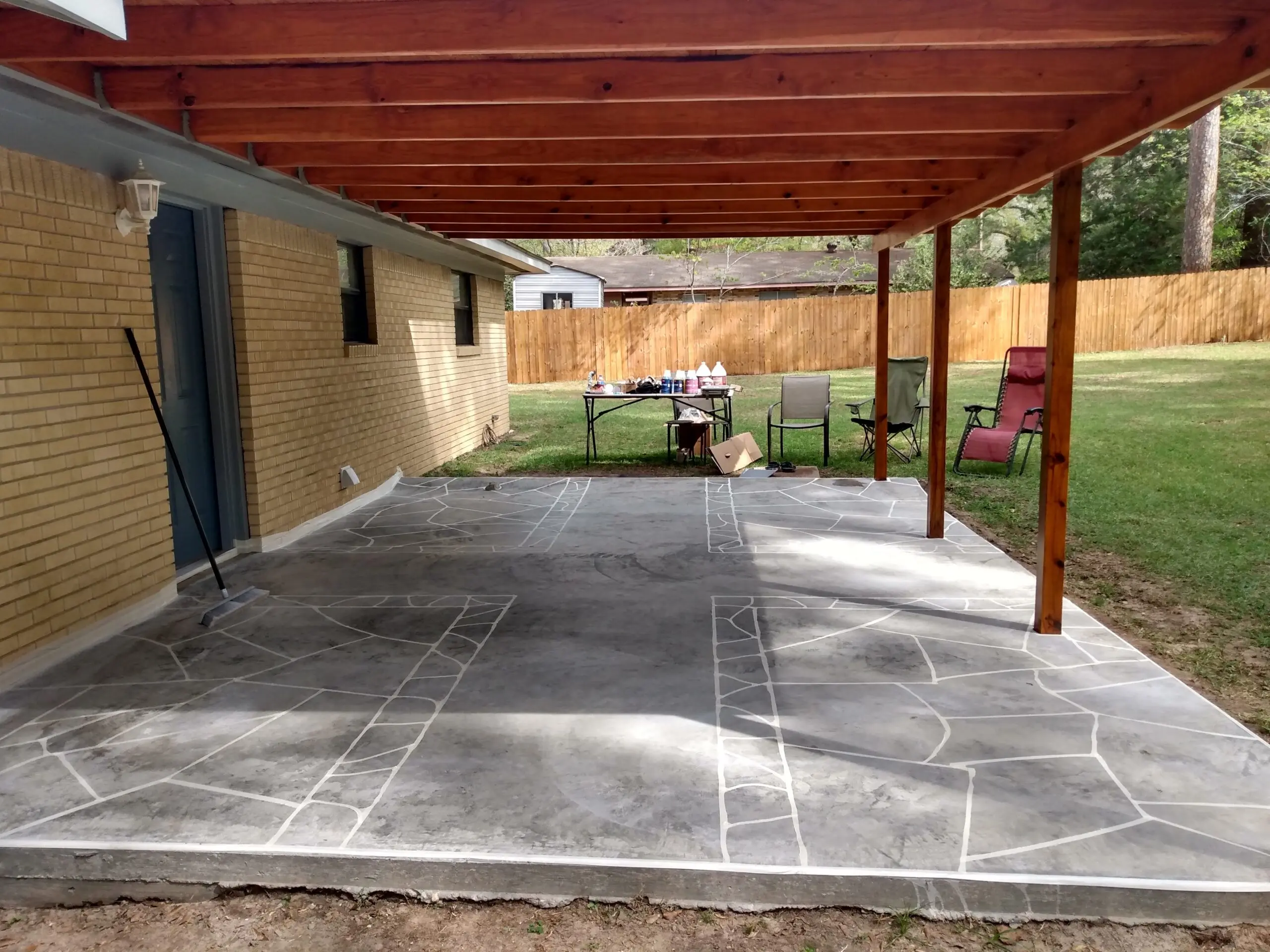 Image showing a porch with sections taped off, preparing for the application of the faux flagstone design using acid stains