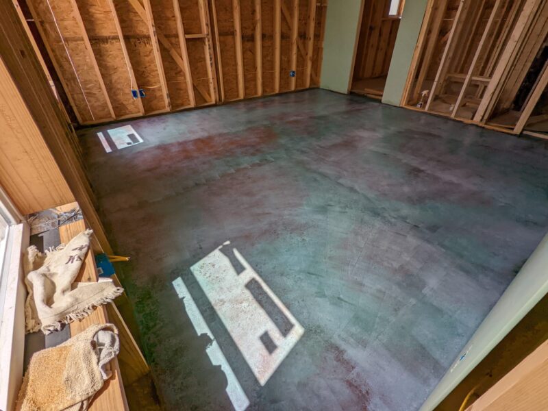 A photo of a dry concrete floor with the acid stain fully dried and ready to be neutralized before the final cleaning and rinsing process