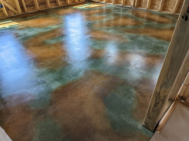 Acid stained and sealed concrete floor after second coat of ProWax Polish™ application, satin finish enhances vibrant colors making the surface look even more beautiful