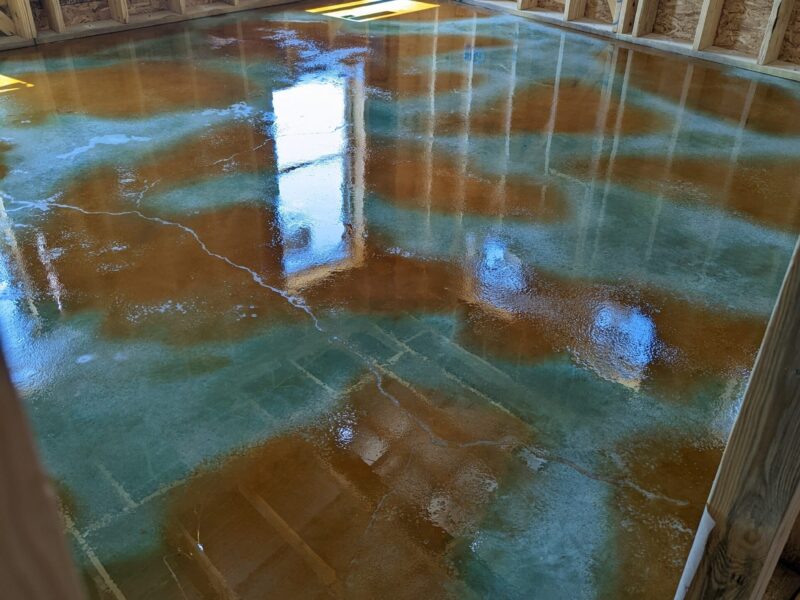 A photo of a concrete floor stained wet-on-wet with the Malayan Buff accent color over on Seagrass base color acid stain