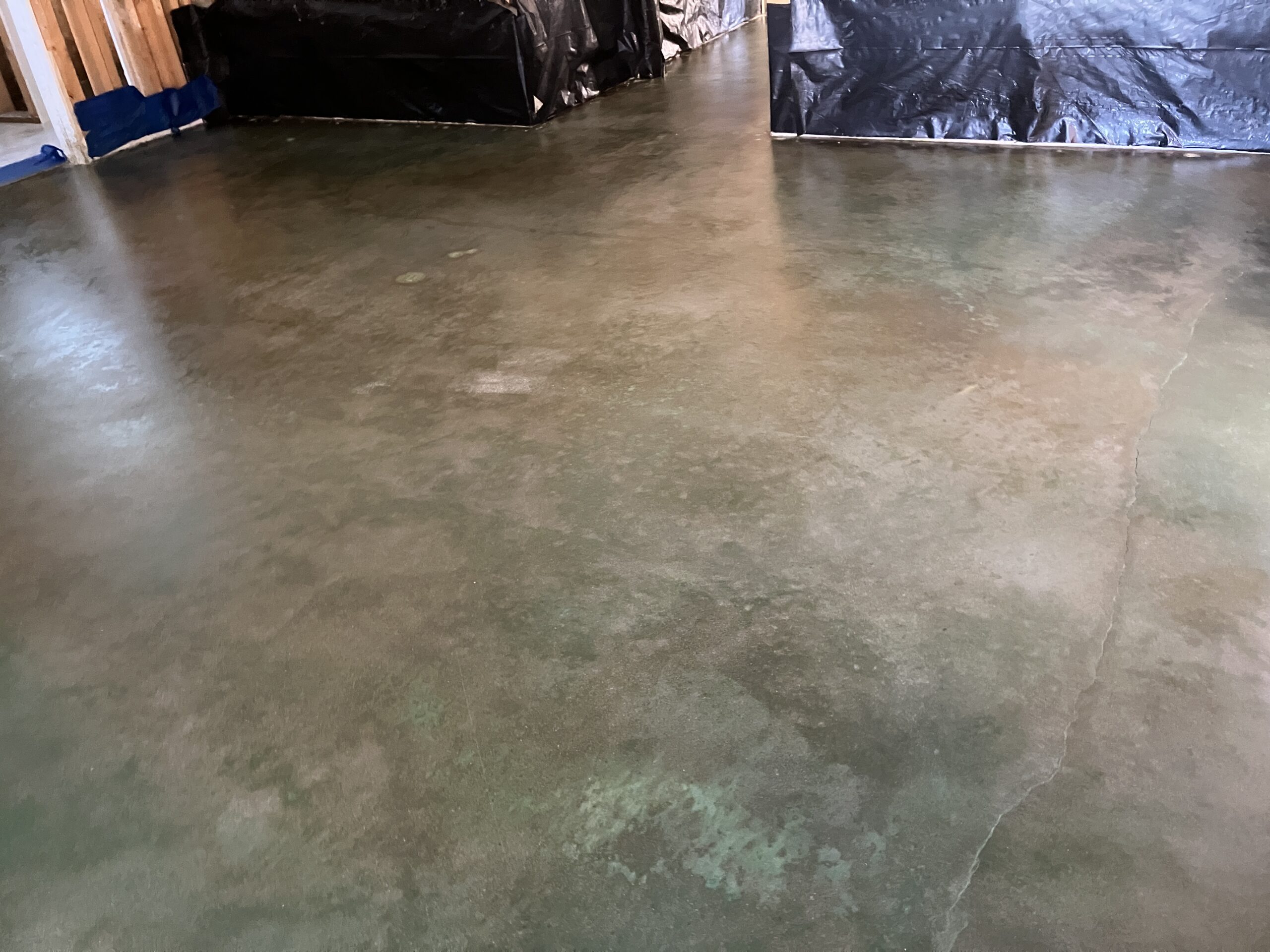 Image of the beautifully transformed floors with Seagrass and Black stained concrete floors.