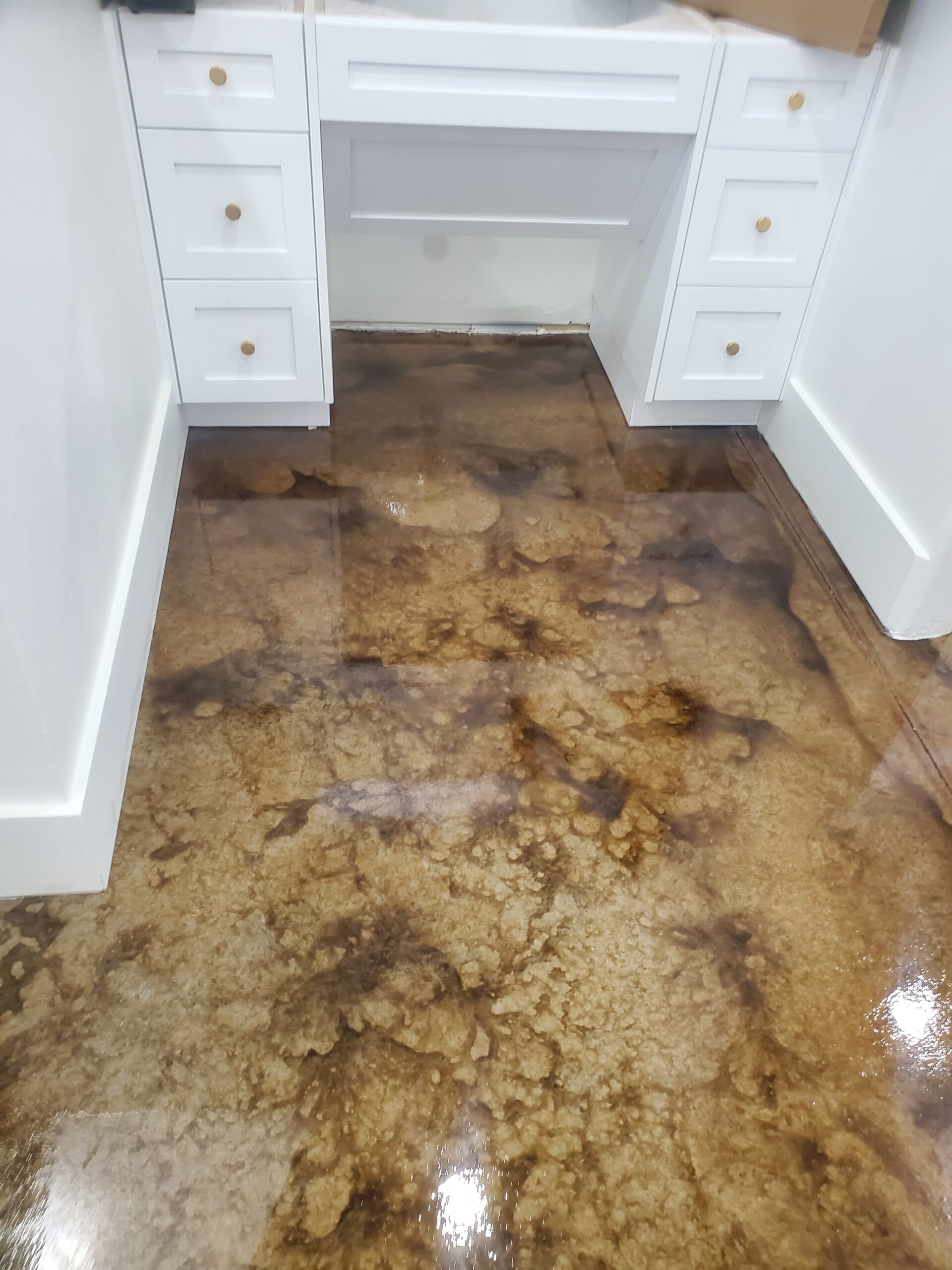 Dark marbled acid-stained floor with Black and English Red, contrasting white cabinetry