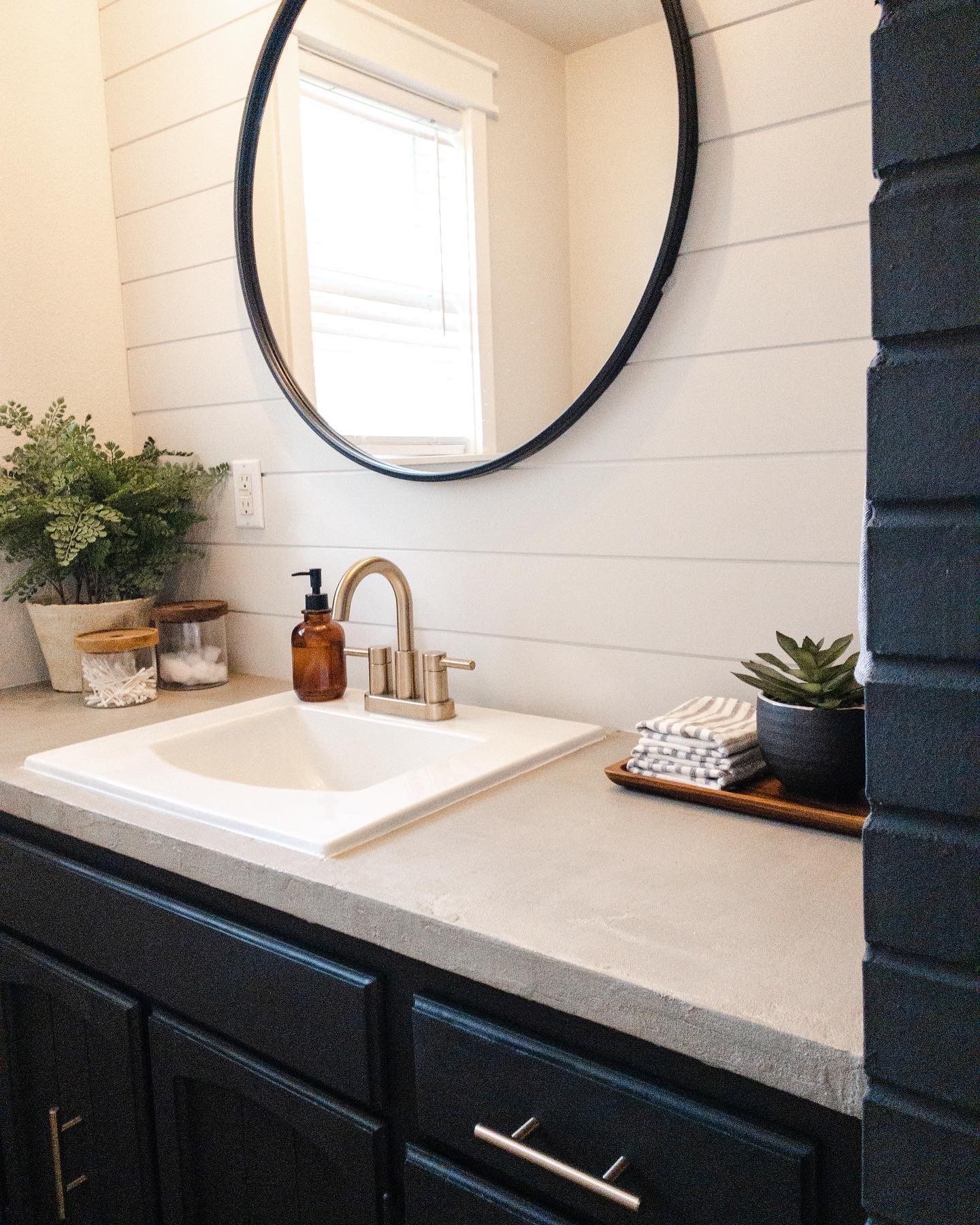 Updated bathroom countertop featuring a sleek and durable Ash Concrete Overlay applied over a Formica surface