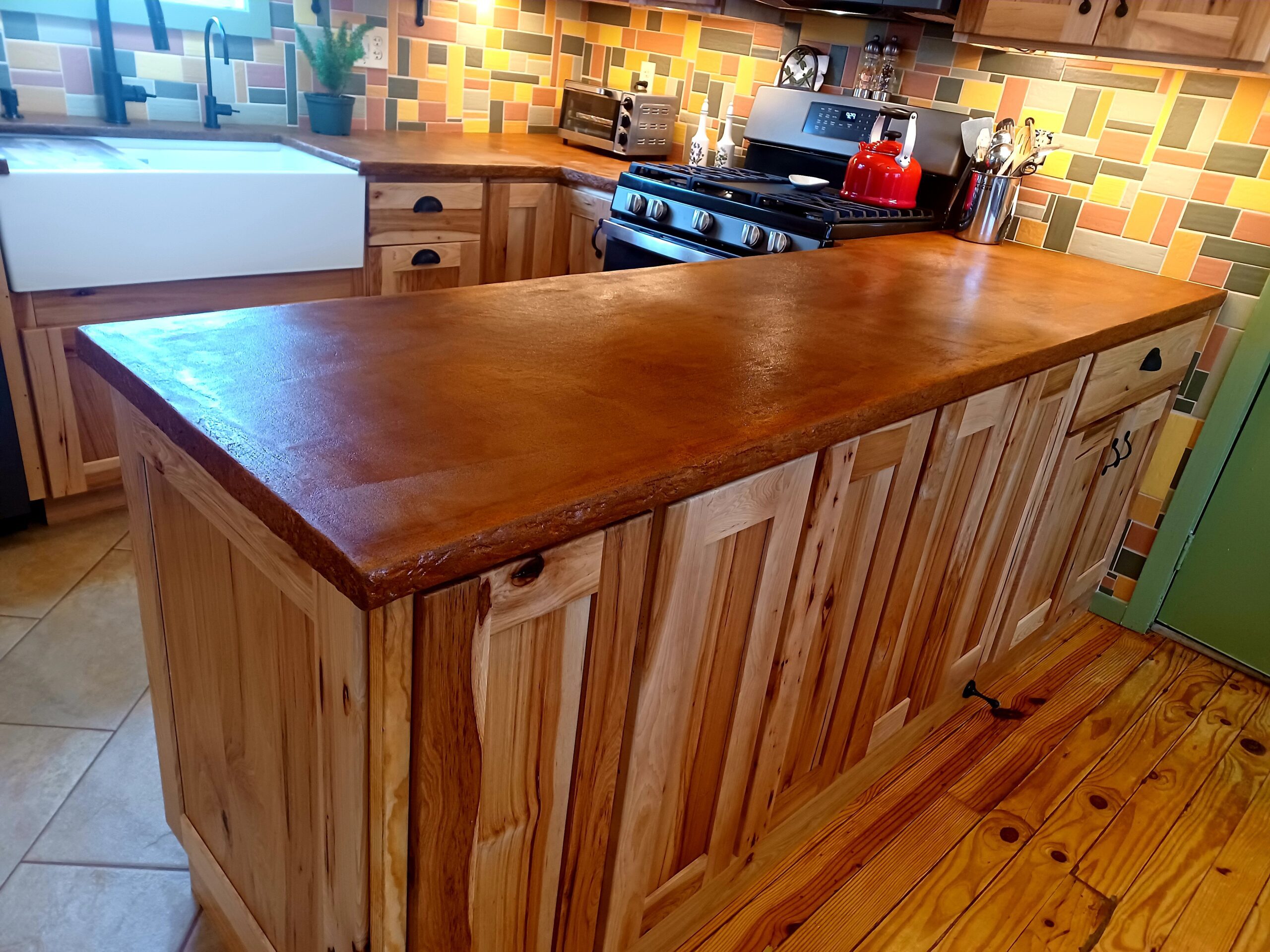 Stunning Cola and Malayan Buff Everstain acid stained finish enhances Beachfront Buff pigmented concrete overlay kitchen countertop.