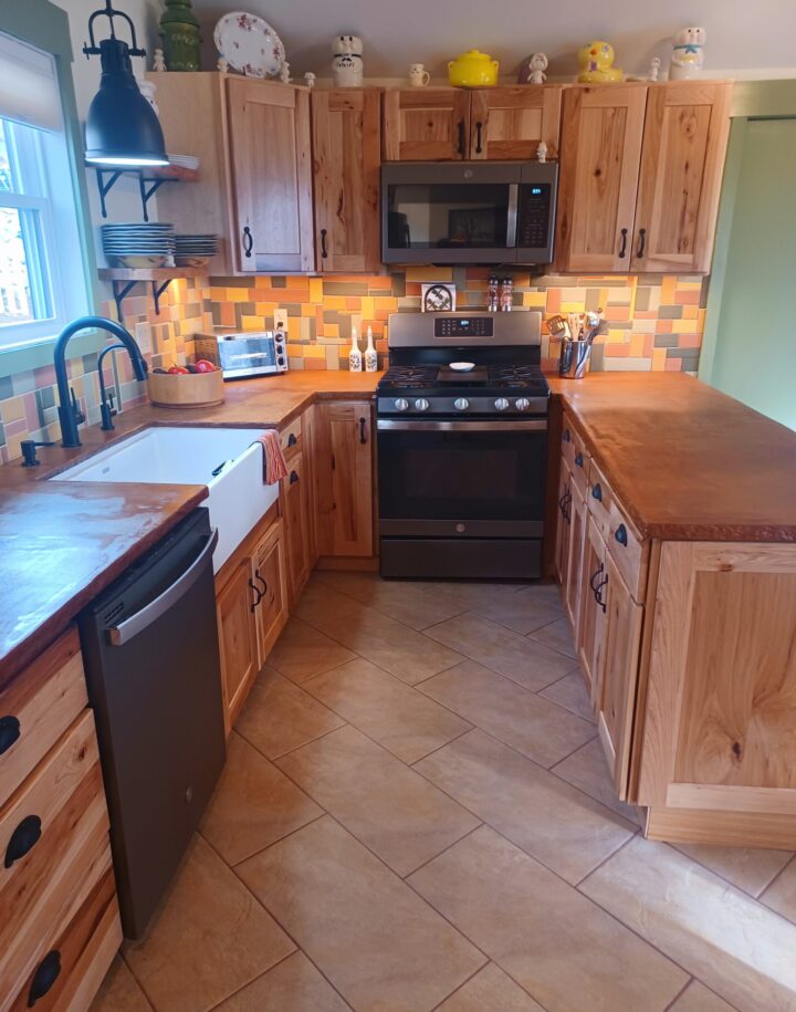 Applying the first coat of sealer to an acid stained concrete overlay countertop with Cola and Malayan Buff Everstain acid stains