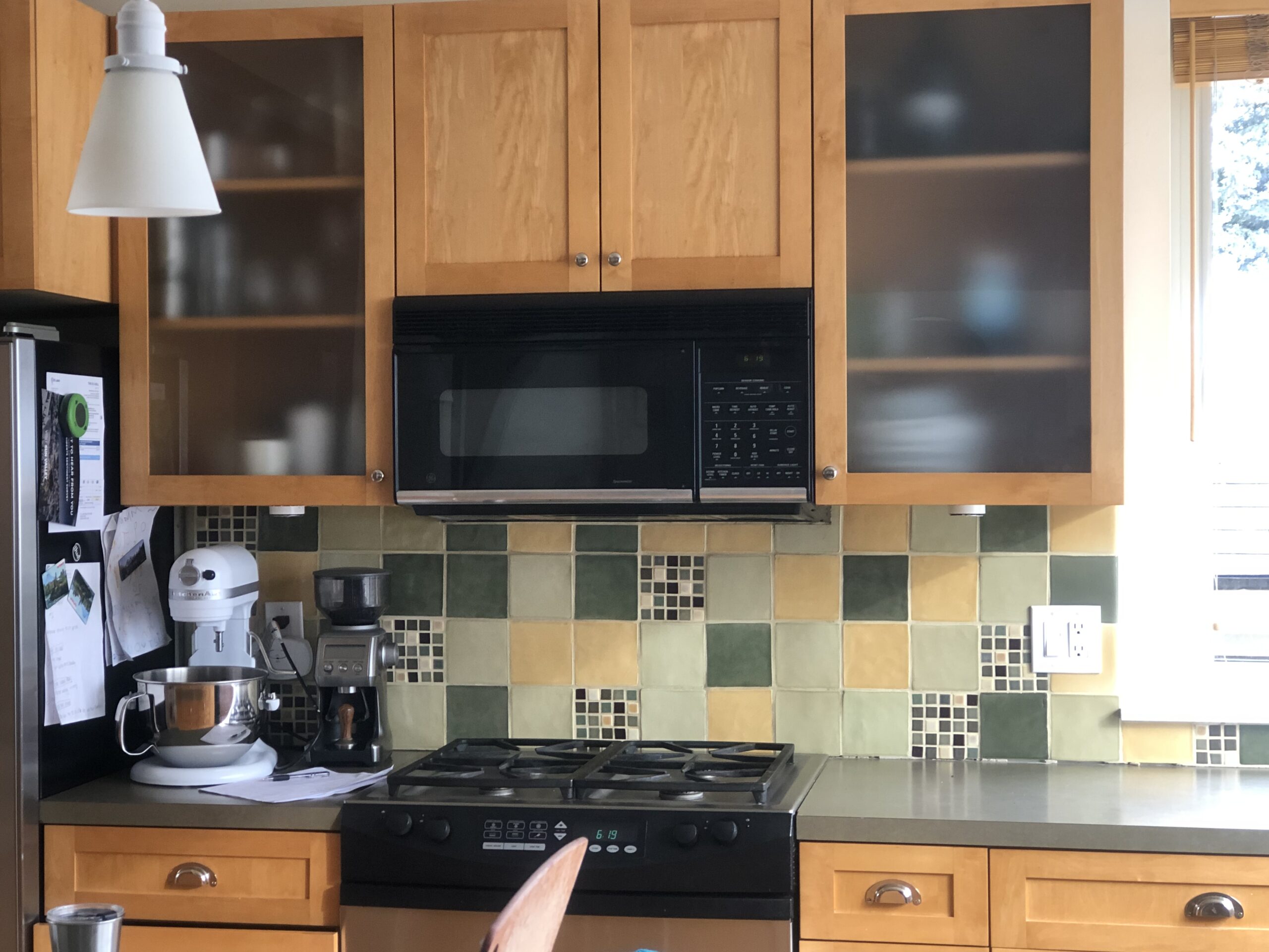 Outdated Formica kitchen countertops and tiled backsplash