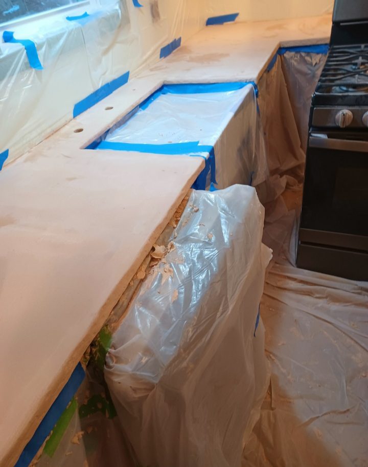 Adding an integrally colored skim coat of Beachfront Buff concrete overlay around the sink opening on a plywood constructed kitchen countertop