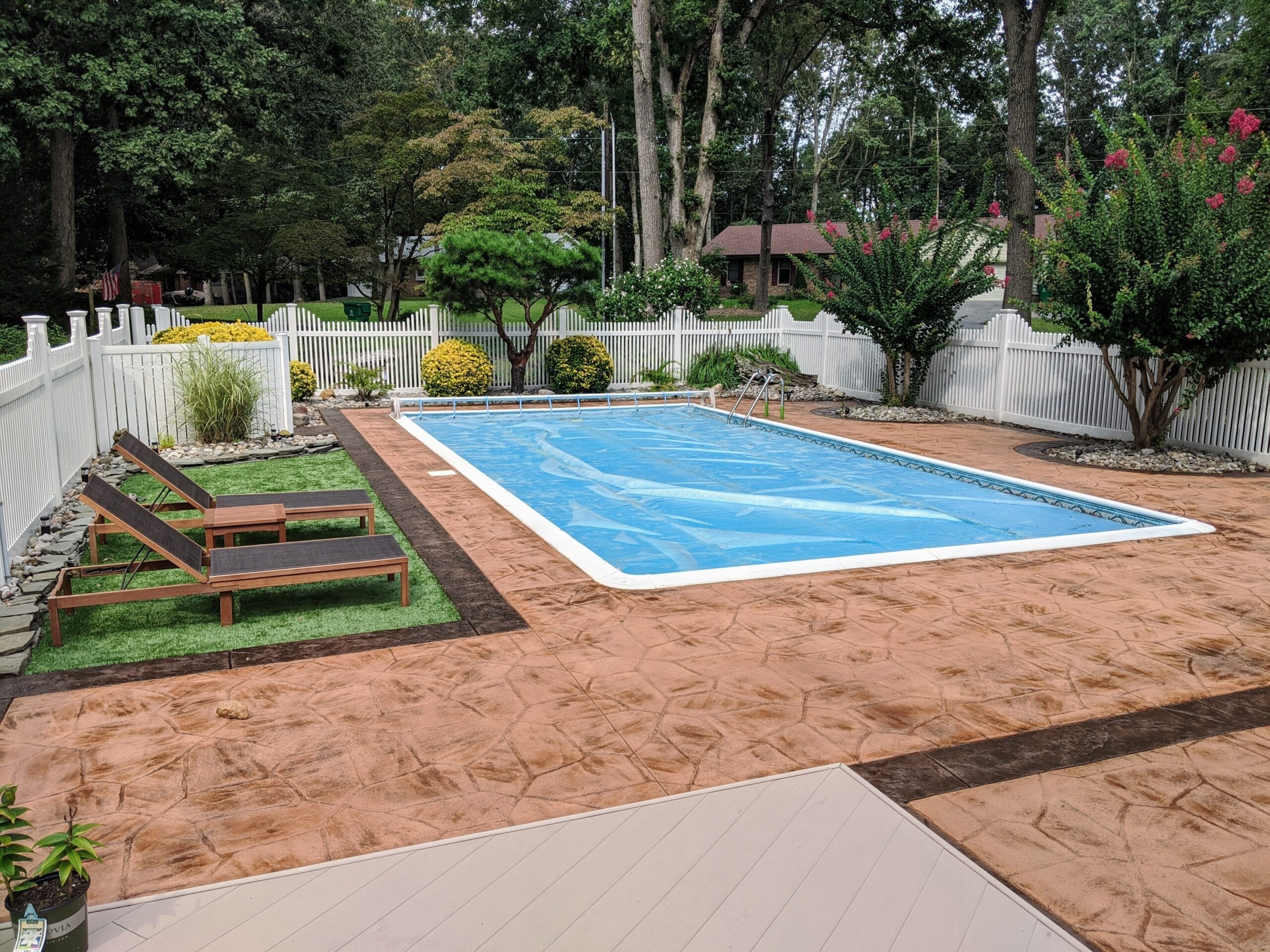 A Poolside Masterpiece: The elegant transformation of the once-drab stamped concrete pool deck, now adorned with a sophisticated stain and sealed for lasting beauty and safety
