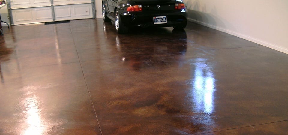 Concrete garage floor that has been recently concrete acid stained and finished with an indoor concrete sealer.