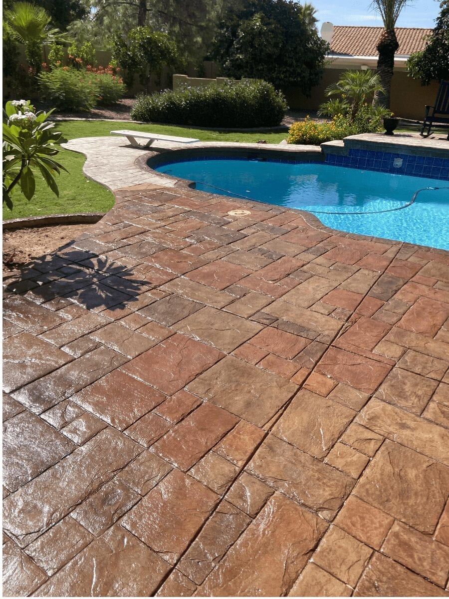 Revived stamped concrete pool deck with Antiquing Cumin, Driftwood, and Terracotta Concrete Stain Colors