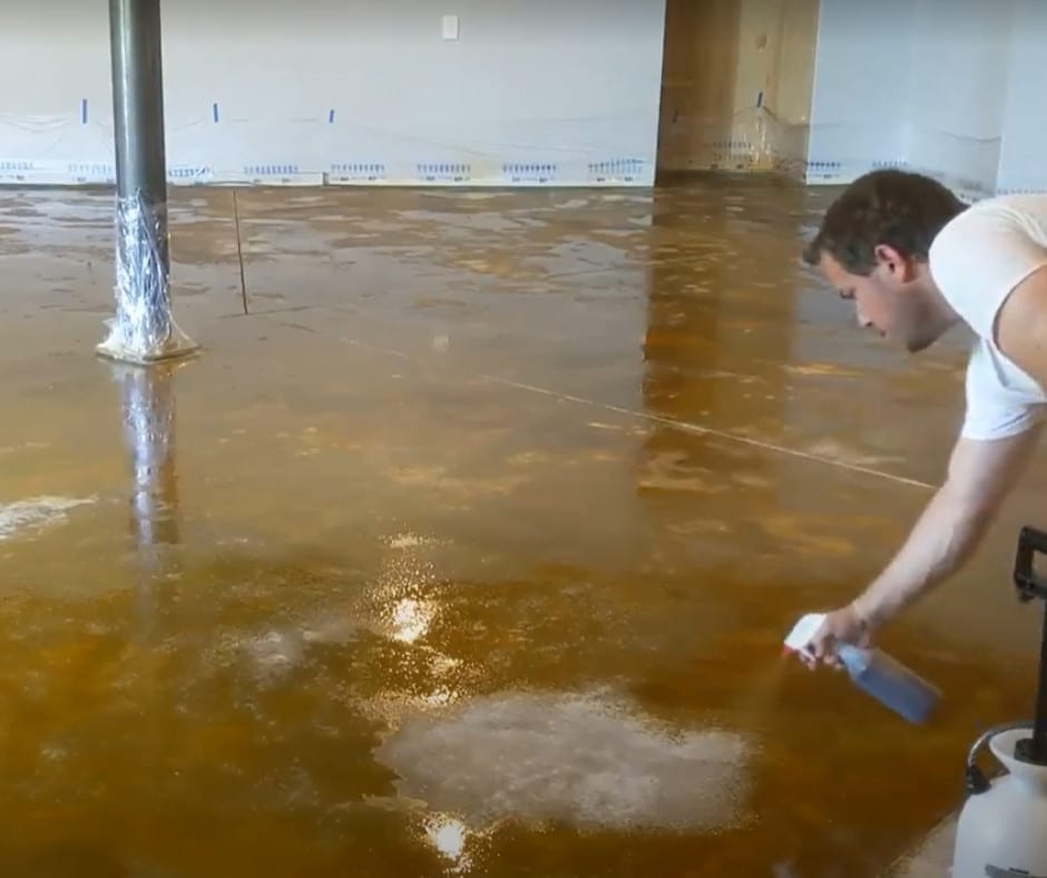 Apply base acid stain color with pump-up sprayer