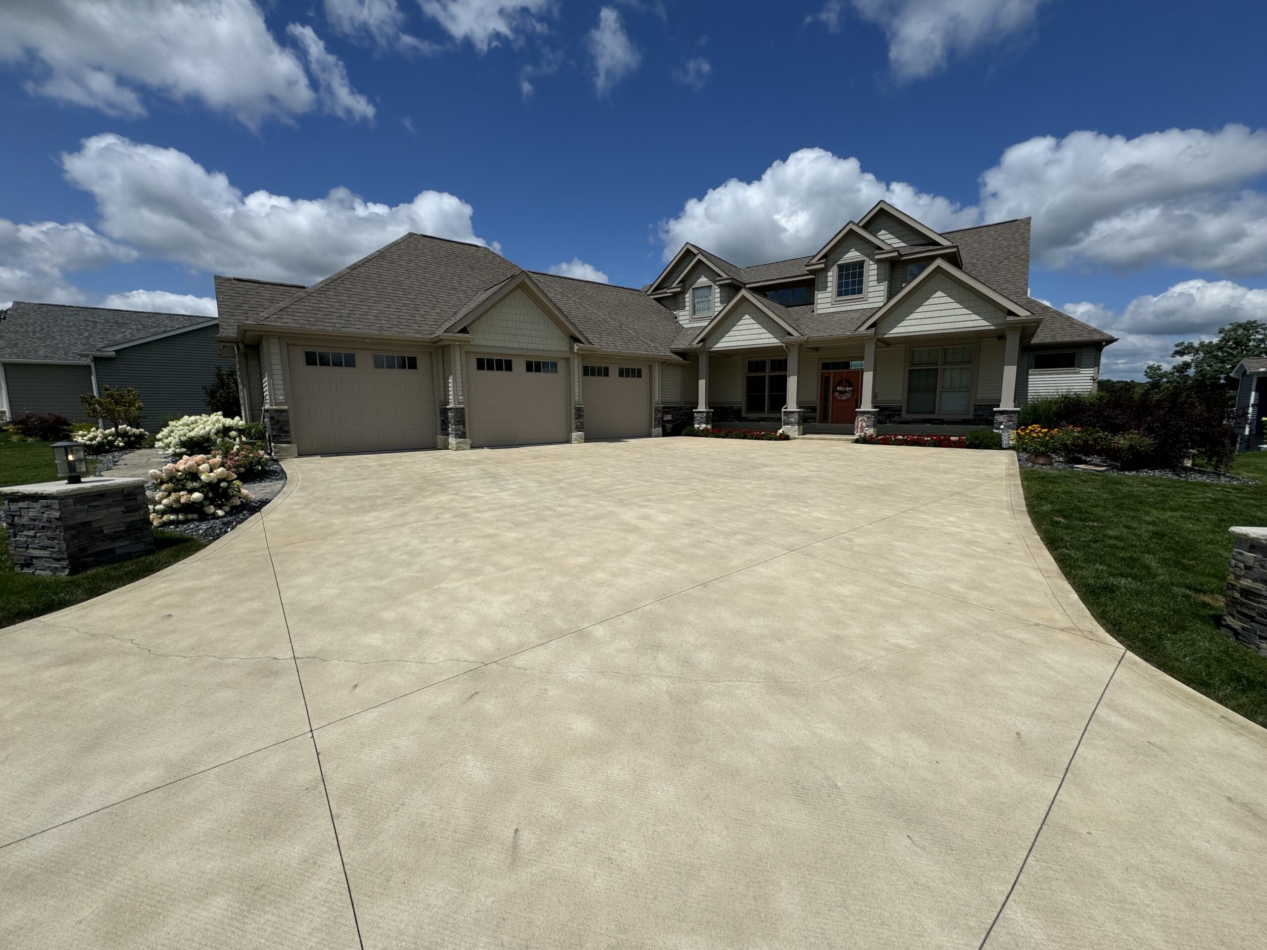 After staining: Broom finished driveway enhanced with Buff Antiquing Stain under clear skies