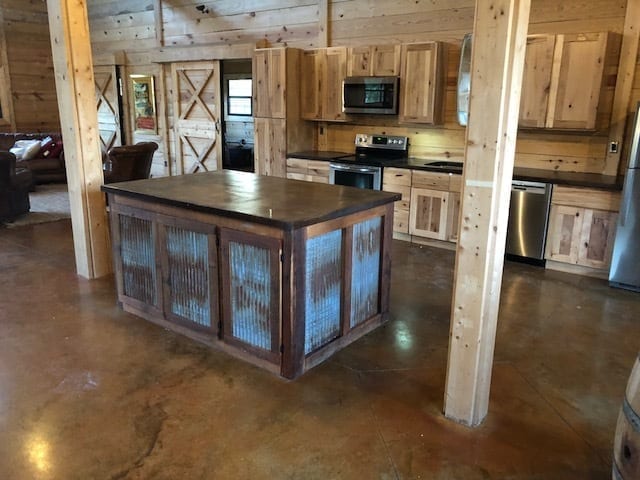 Kitchen area featuring rustic, farmhouse-style flooring enhanced with the warm hues of Malayan Buff and Desert Amber acid stain