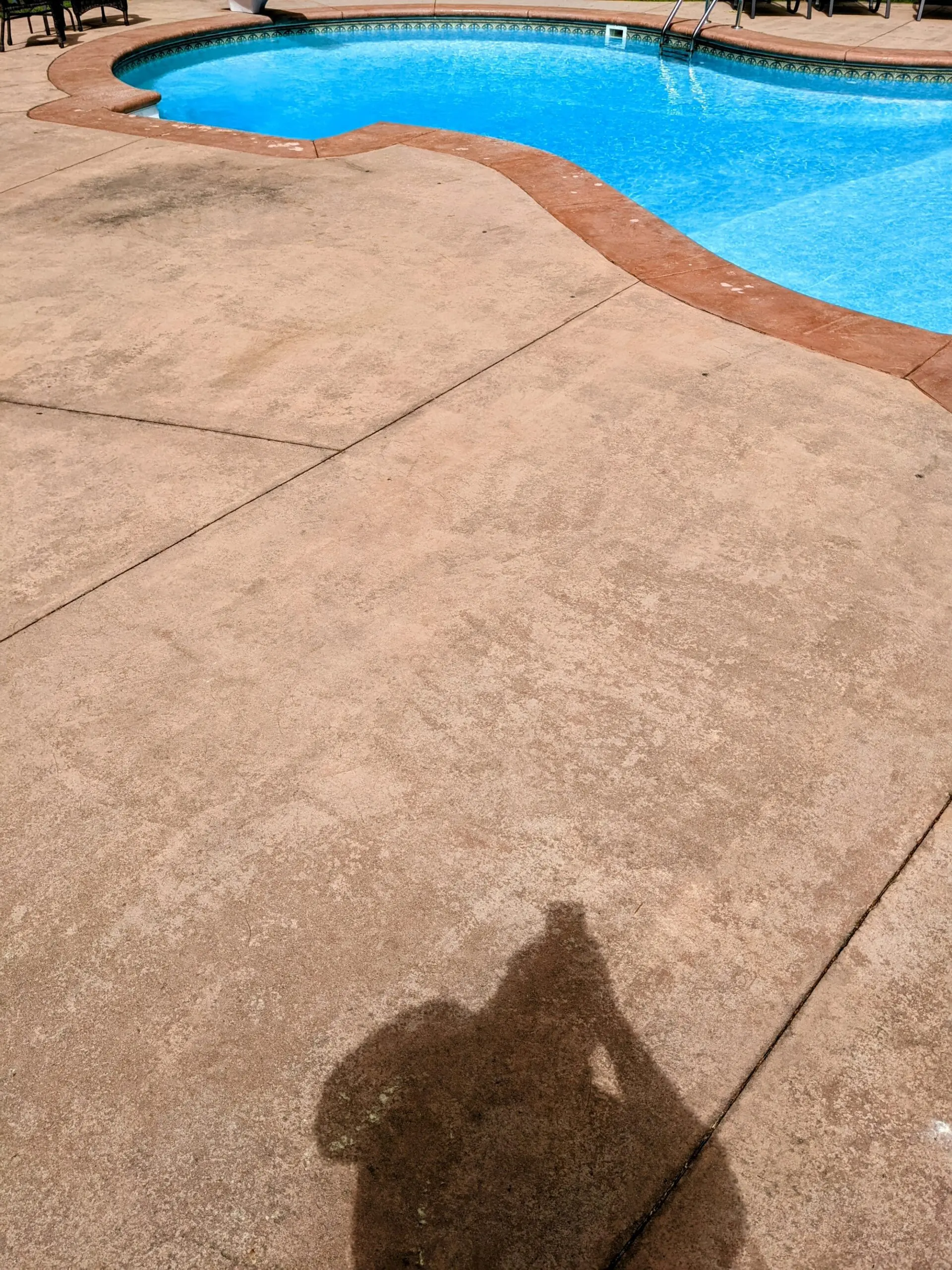 Faded and weathered pool deck concrete prior to renovation