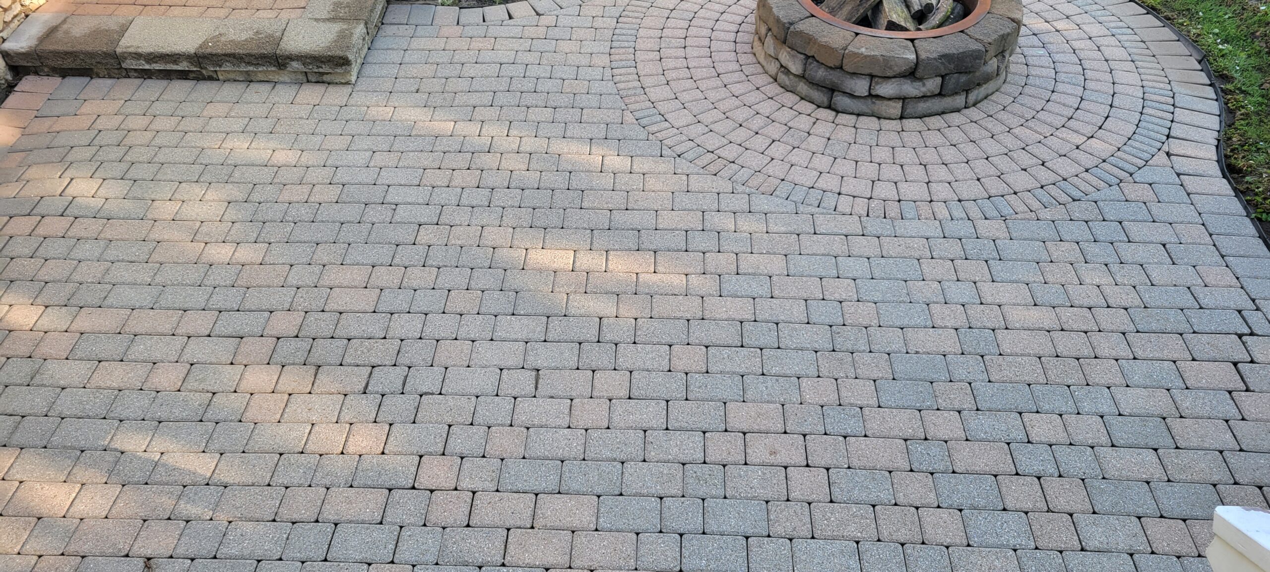 Patio pavers looking refreshed post-power wash, free of moss and dirt