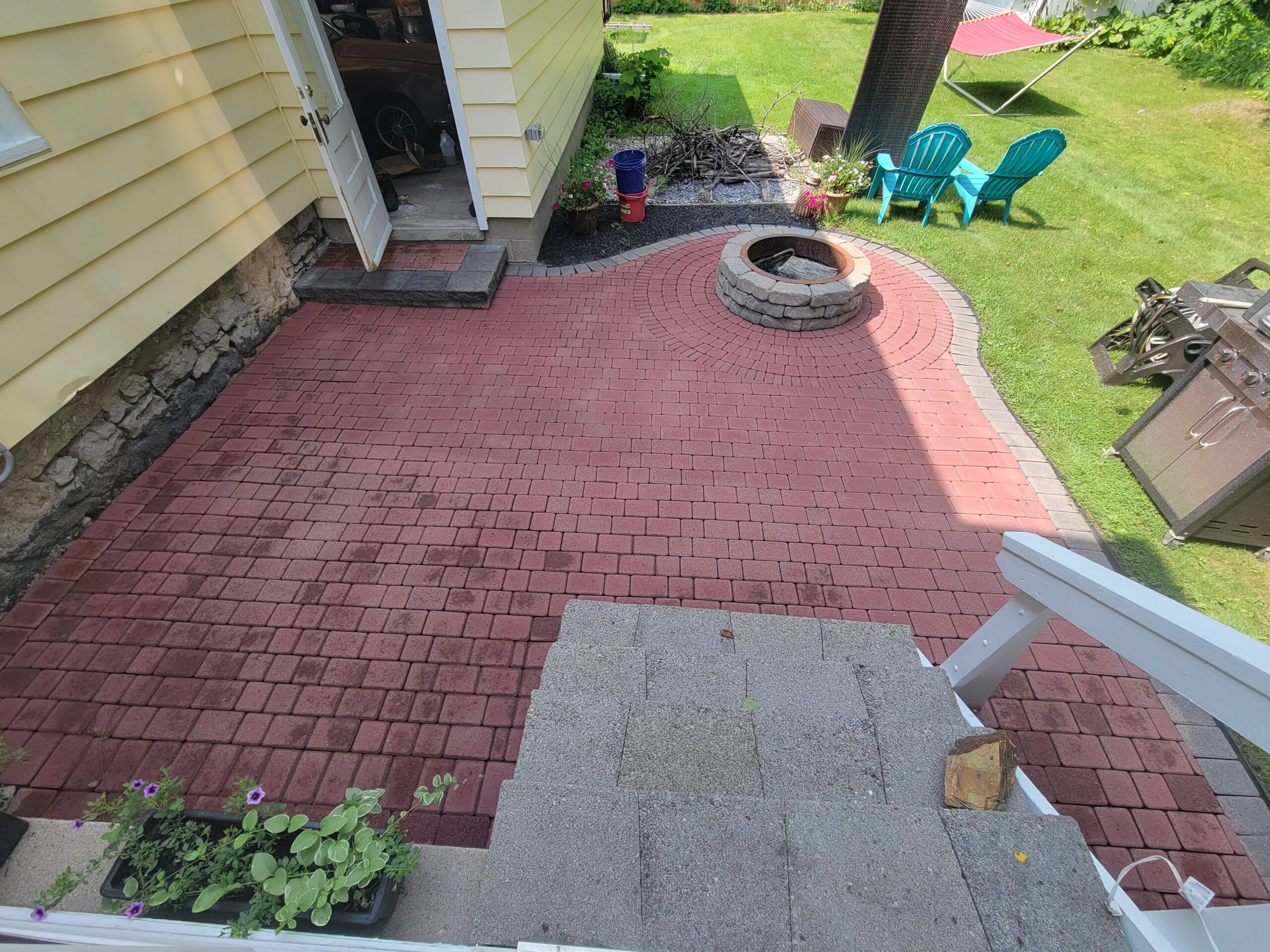 Brightened patio pavers showcasing a vibrant Cinnabar Portico with a distinct Charcoal edge