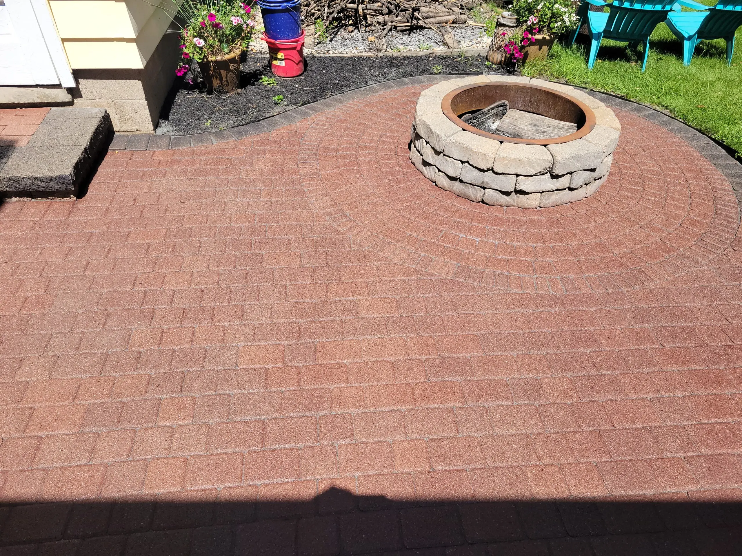 Pavers with grey polymeric sand filled into the joints and a sealed finish