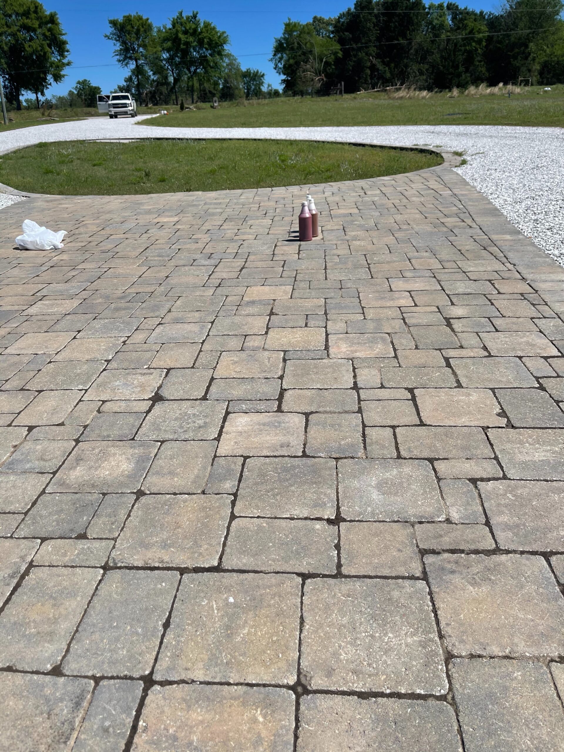 A faded, lackluster paver driveway in need of a color refresh