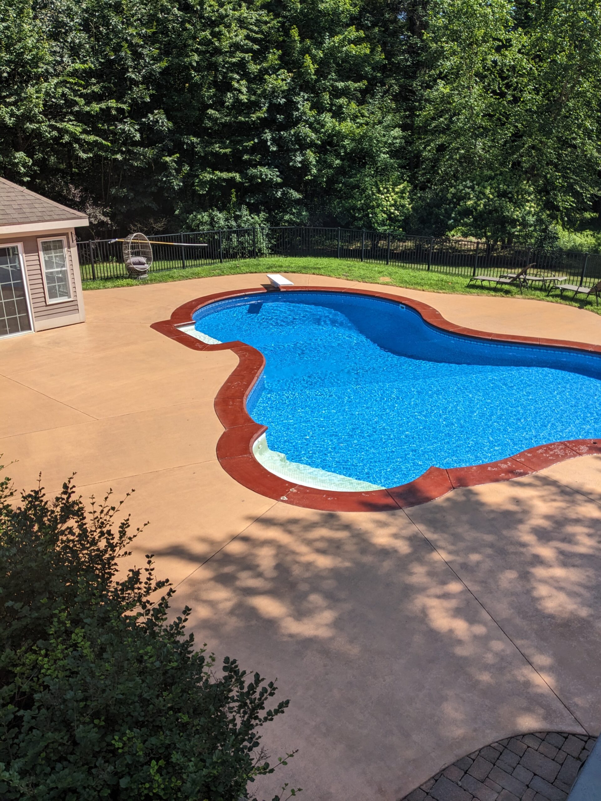 Refreshed pool deck with vibrant Cinnabar and Sunset Tan