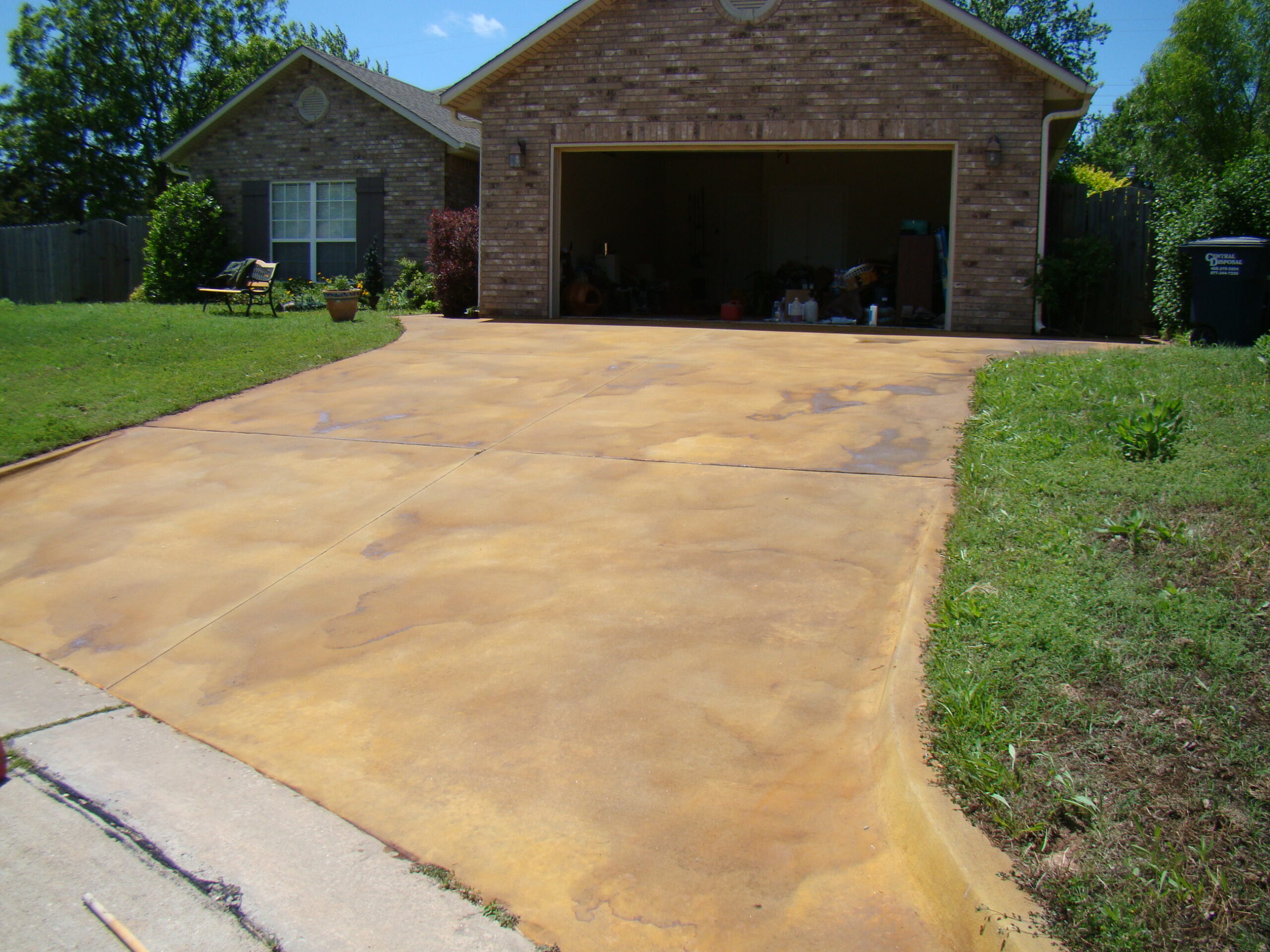 A stained driveway showcasing a mottled look from a blend of Yukon Gold and Goldenrod Antiquing stains