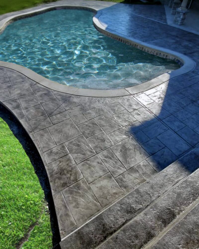 black stained stamped concrete pool deck that's both beautiful and durable