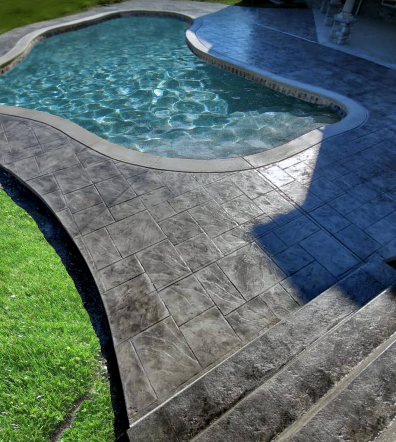 black stained stamped concrete pool deck that's both beautiful and durable