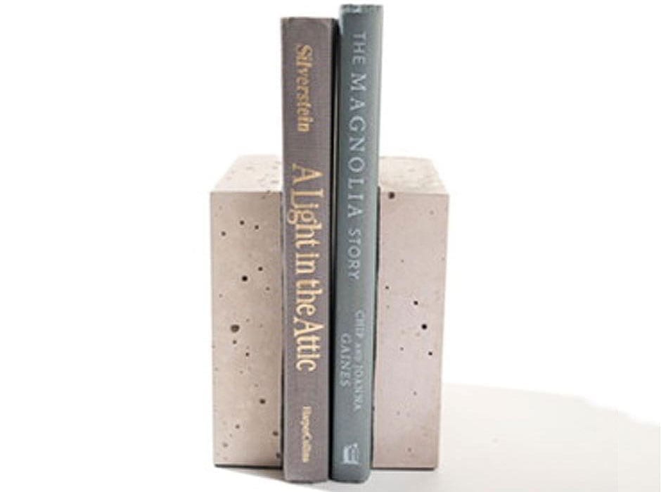 DIY Concrete bookends hold up "A Light in the Attic" and "The Magnolia Story" against a white backdrop