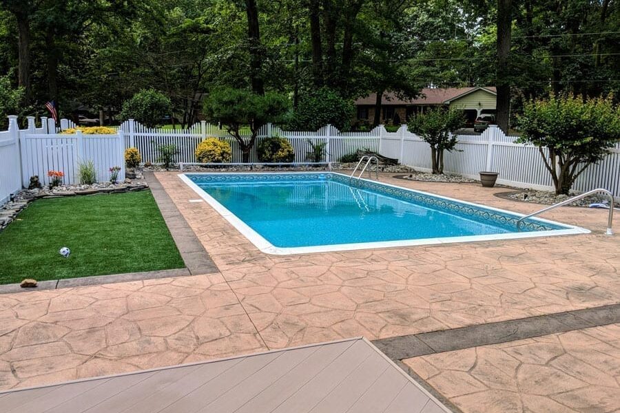 Before photo of a faded stamped concrete pool deck