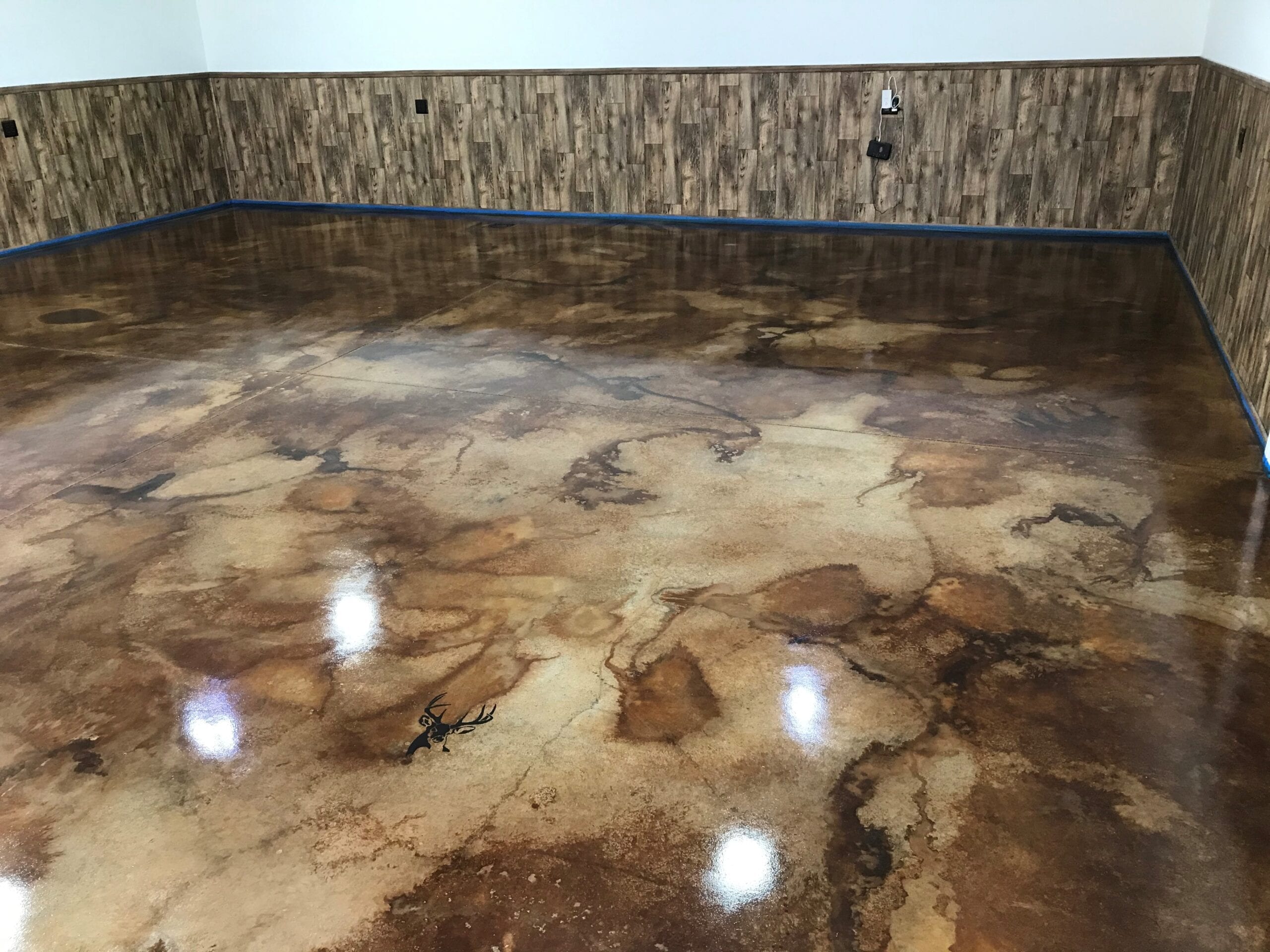 Wet-on-wet technique being used to apply Desert Amber, Cola, and Coffee Brown acid stains to garage floor