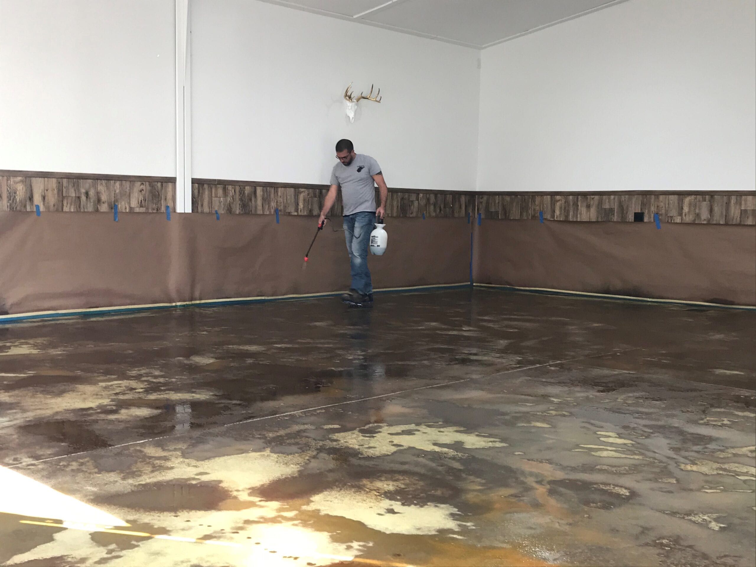 Wet-on-wet technique being used to apply Desert Amber, Cola, and Coffee Brown acid stains to garage floor