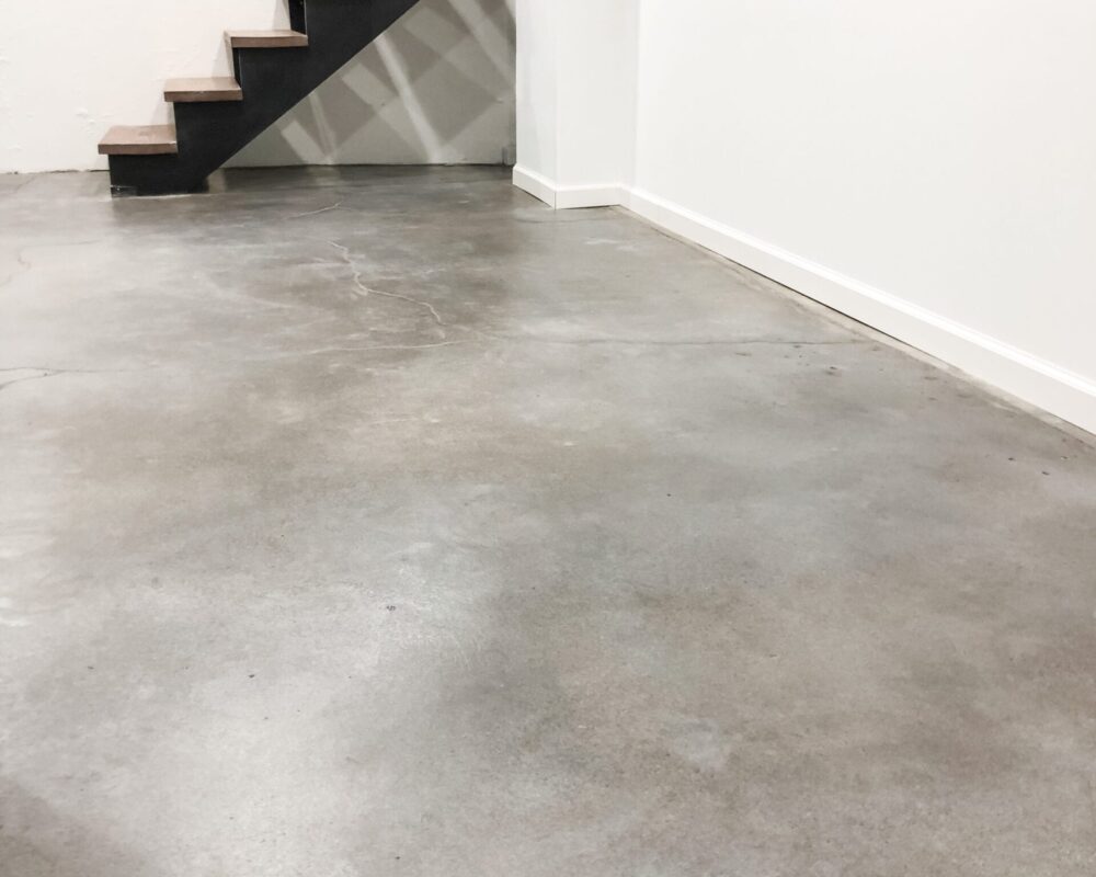 Faux polished concrete floor in Stormy Gray, White, Charcoal Vibrance Dye, creating a modern and sleek look