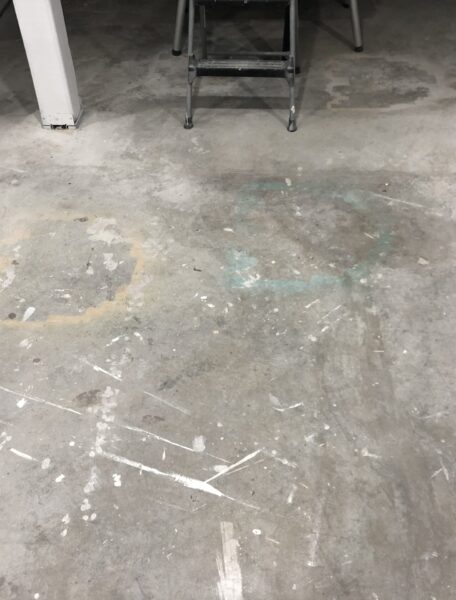 floor with old stains, spray paint and overspray on it