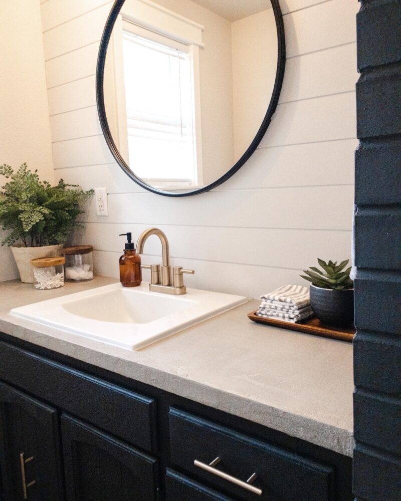 Skim coat of ash gray smooth concrete overlay over laminate bathroom vanity countertop