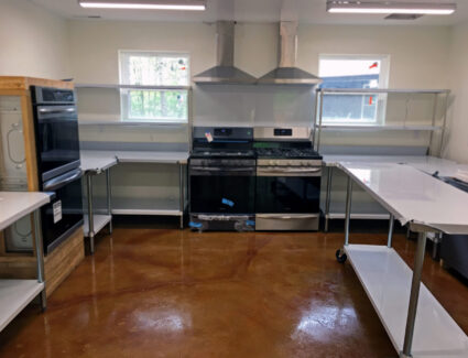 Image showcasing the completed commercial kitchen with the stained and sealed floor