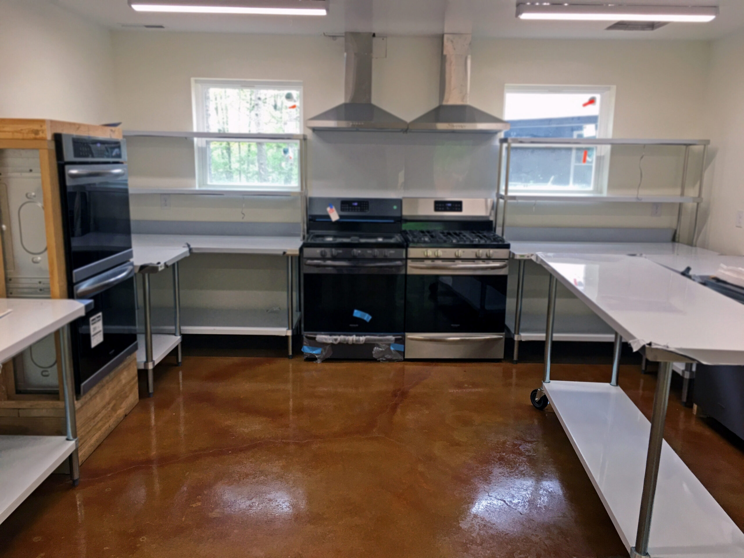 Image showcasing the completed commercial kitchen with the stained and sealed floor