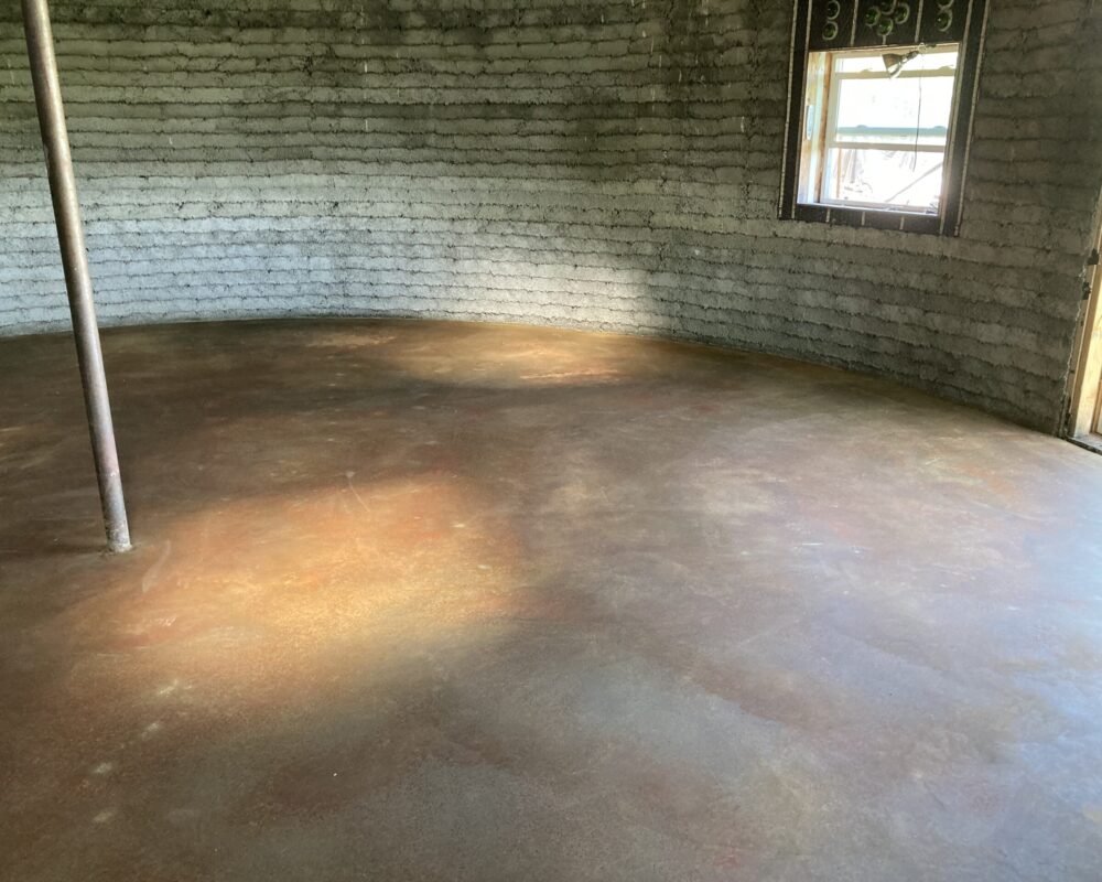 Image of the concrete floor after application and neutralization of Malayan Buff stain, now clean and dry