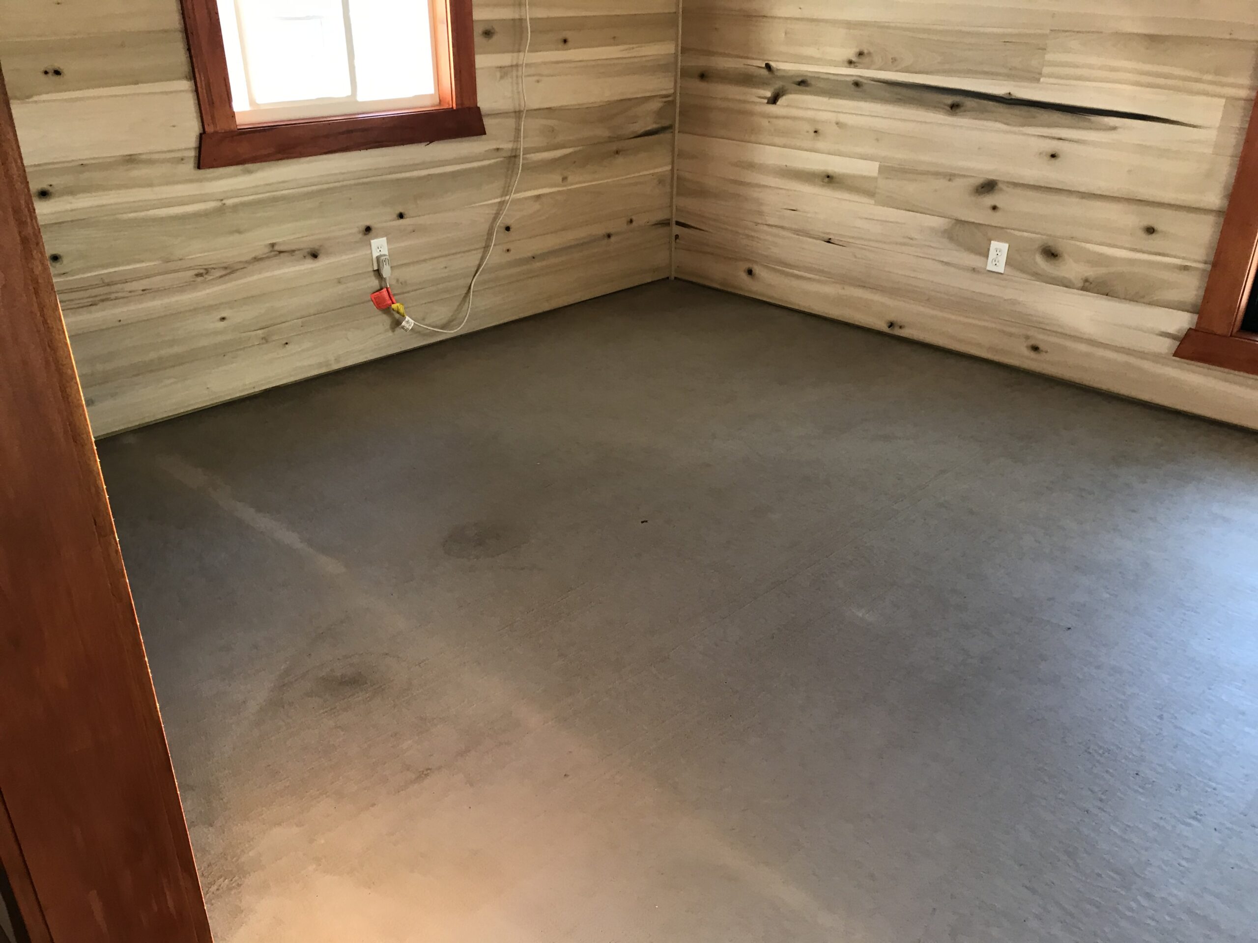 Unstained interior room in a cabin addition, prepped and ready for Cola and Malayan Buff acid stain application
