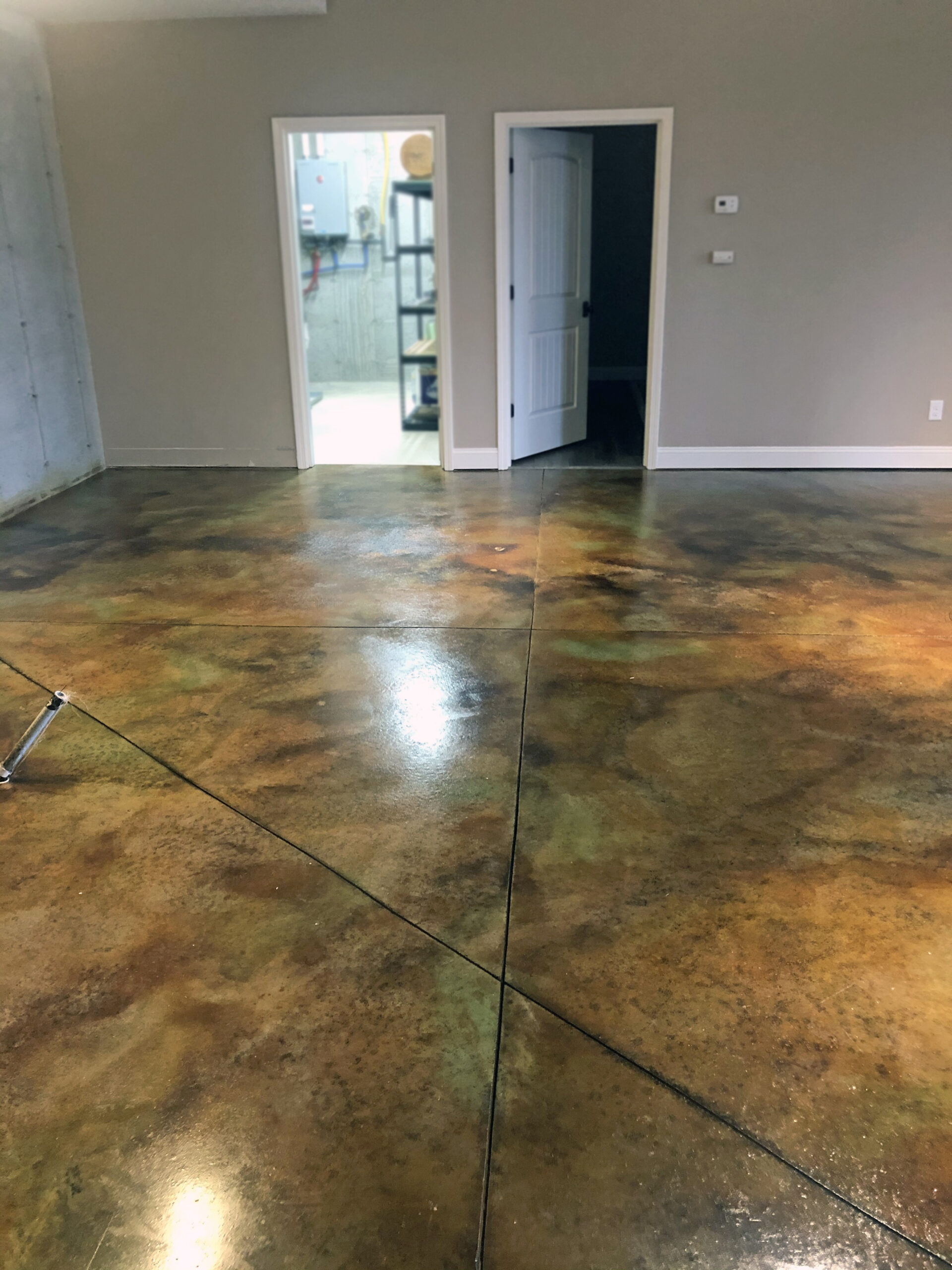Black, malayan buff and seagrass EverStain acid stained lake house concrete floor
