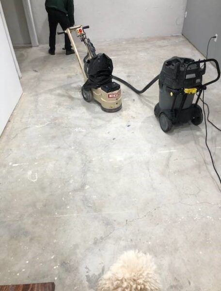 Removing paint and glue with rented concrete grinder