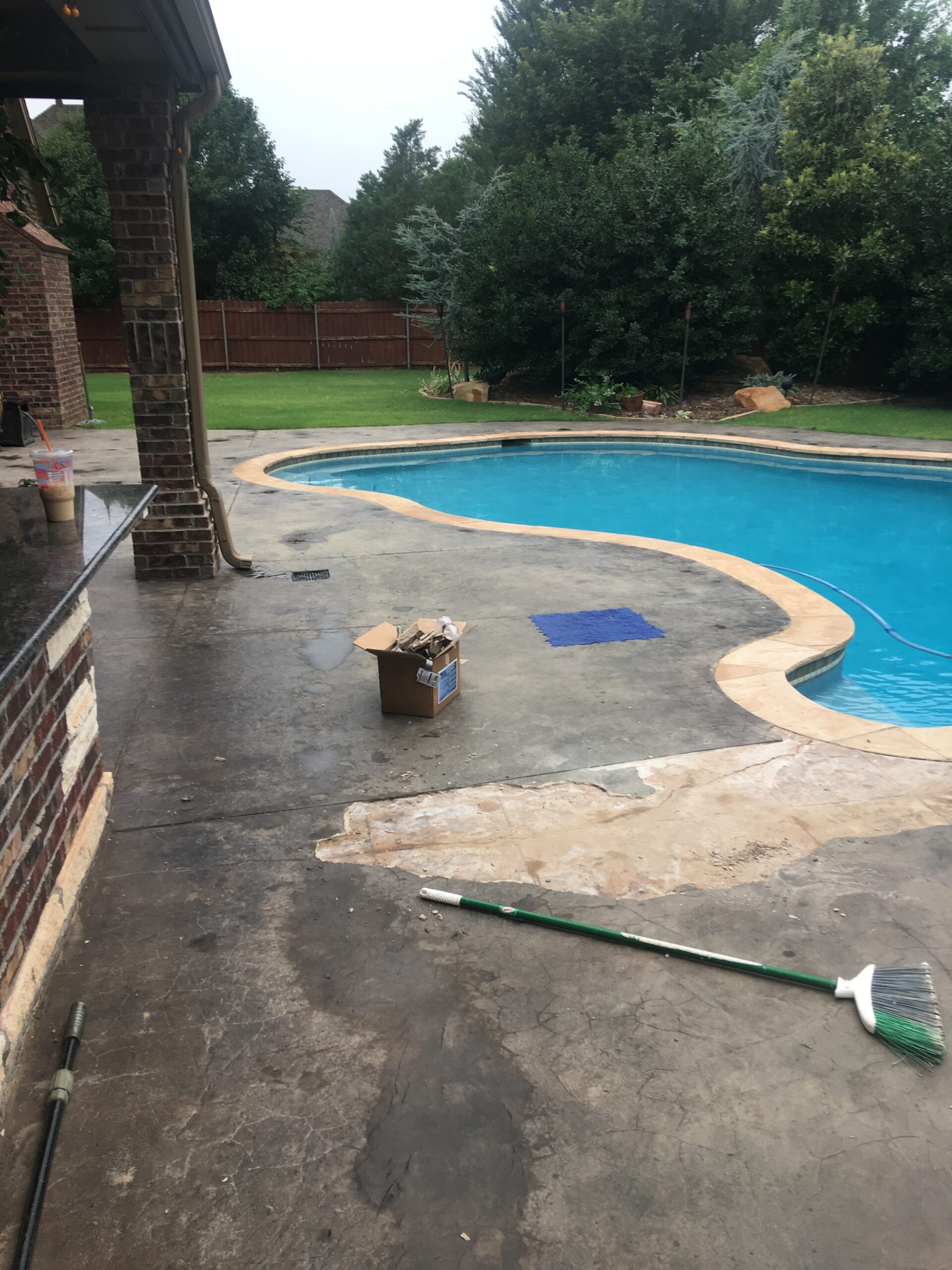 Damaged, peeling concrete pool deck prior to restoration
