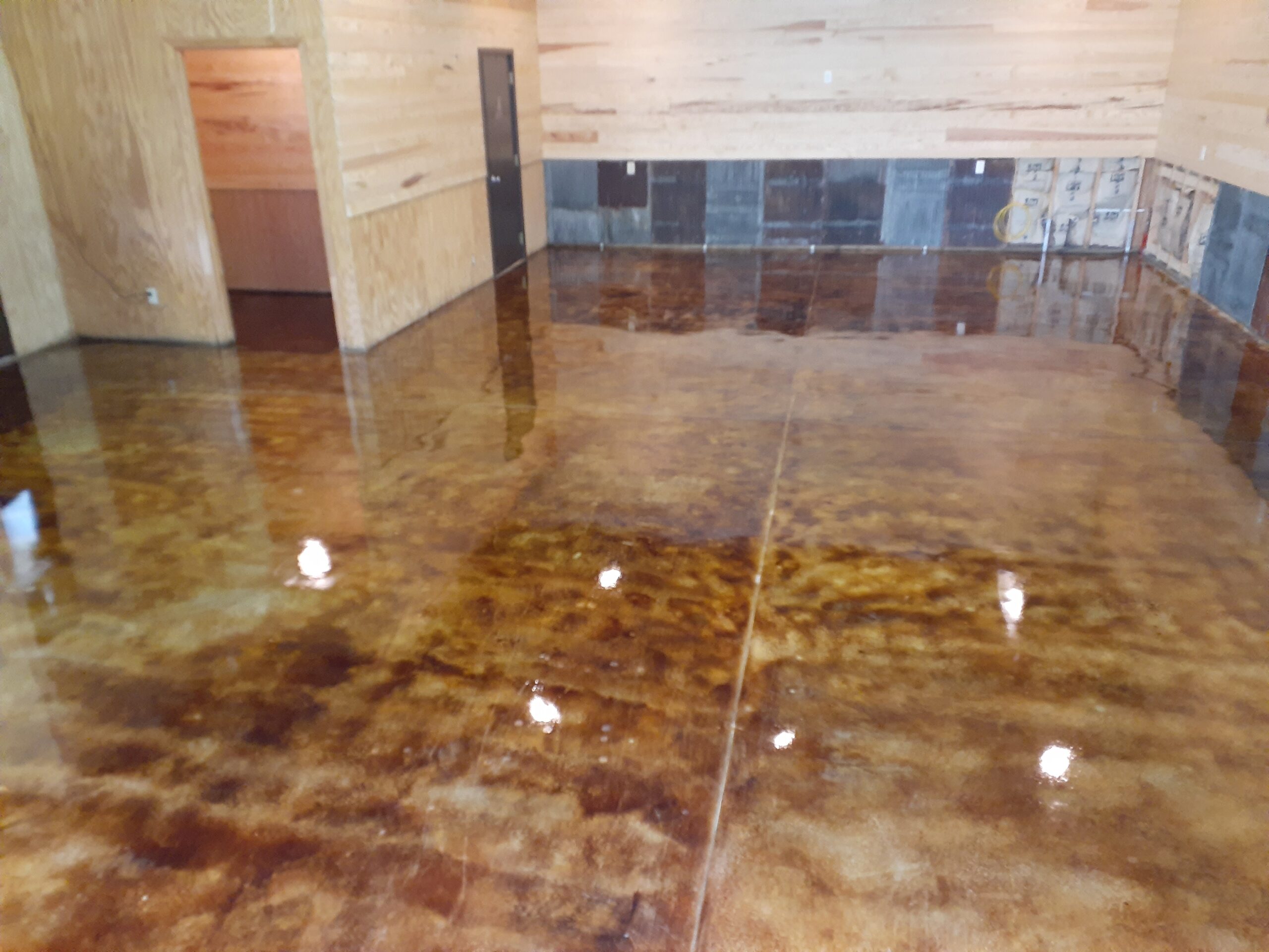 High gloss EasySeal sealer with Anti-Slip additive applied on coffee brown acid stain concrete surface with second coat